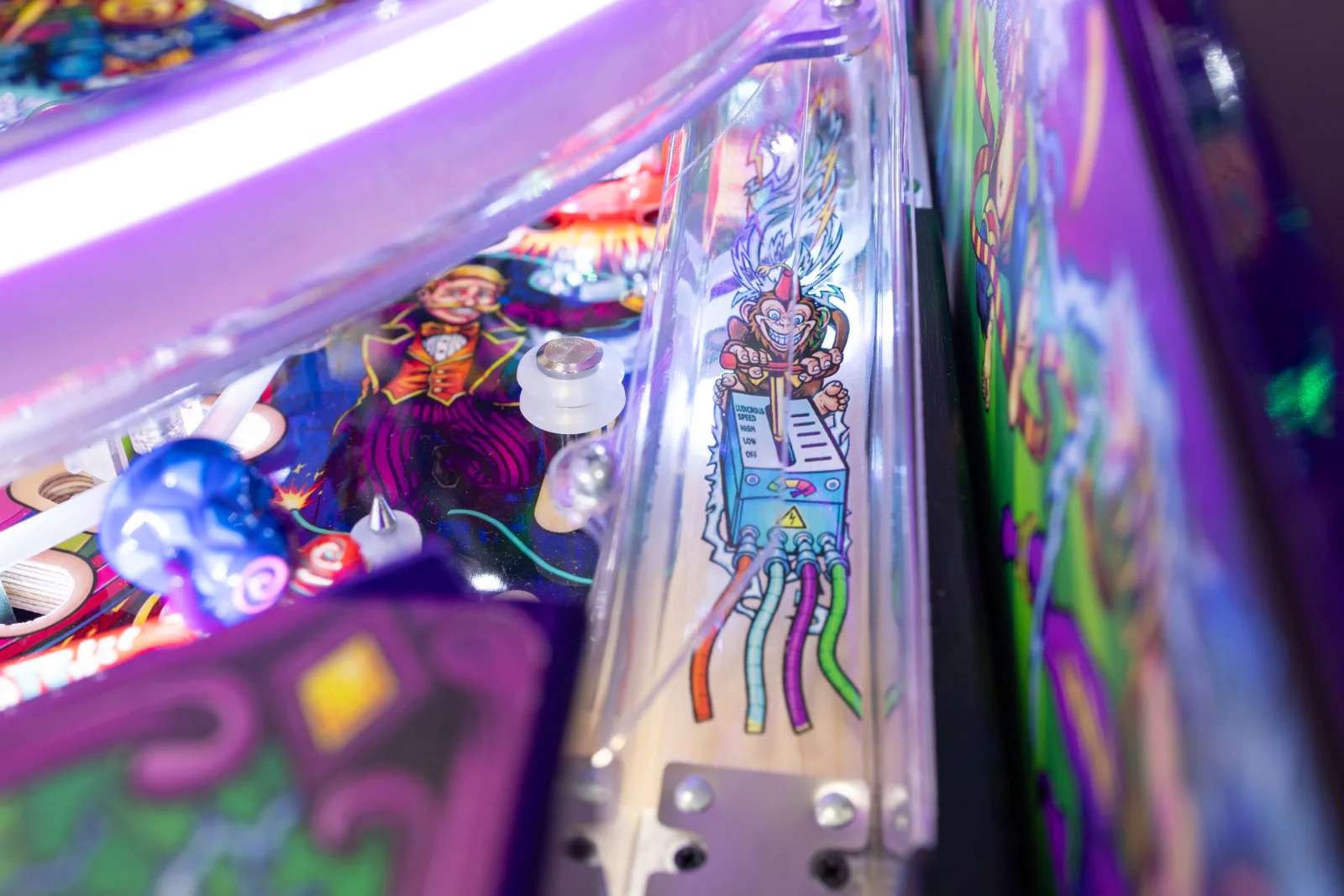 Playfield art of a monkey at a lever box labelled Ludicrous Speed