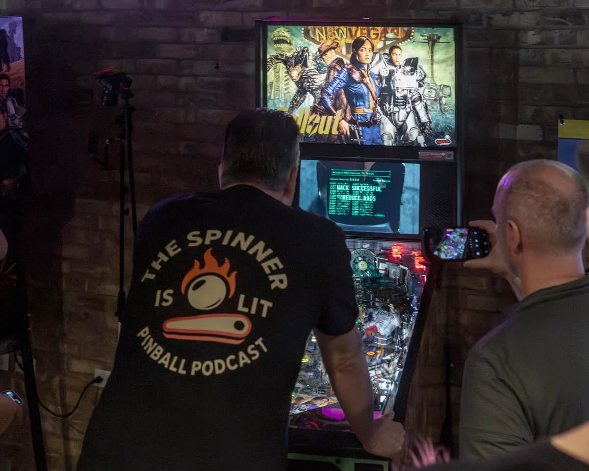 Aaron Schroeder at the Fallout Premium, a hacking terminal on the display, another player filming