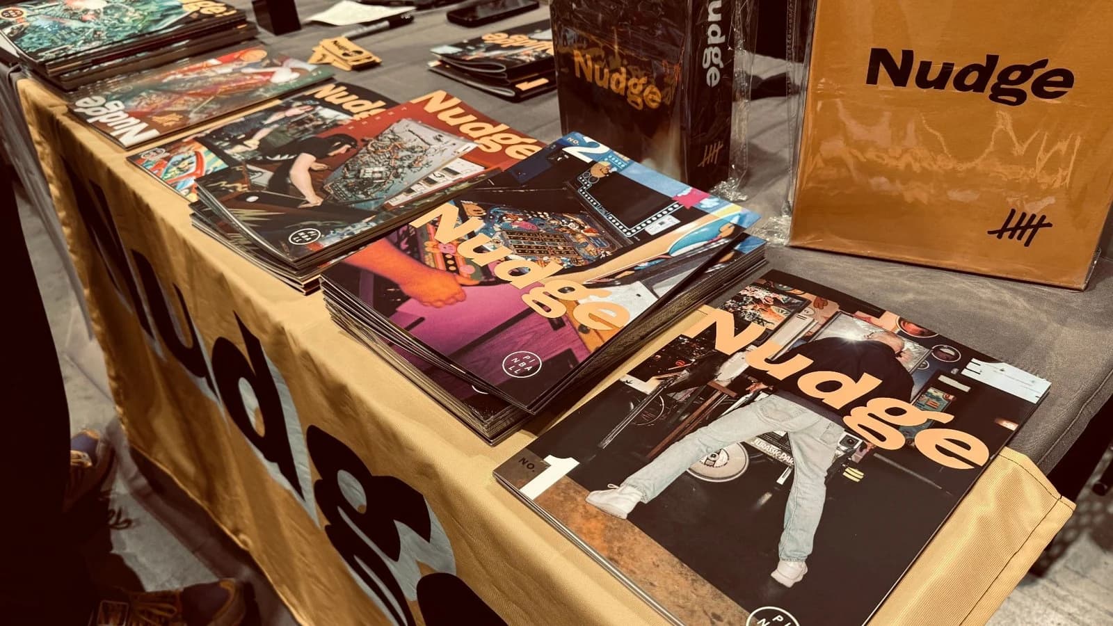 Copies of Nudge magazine on a table