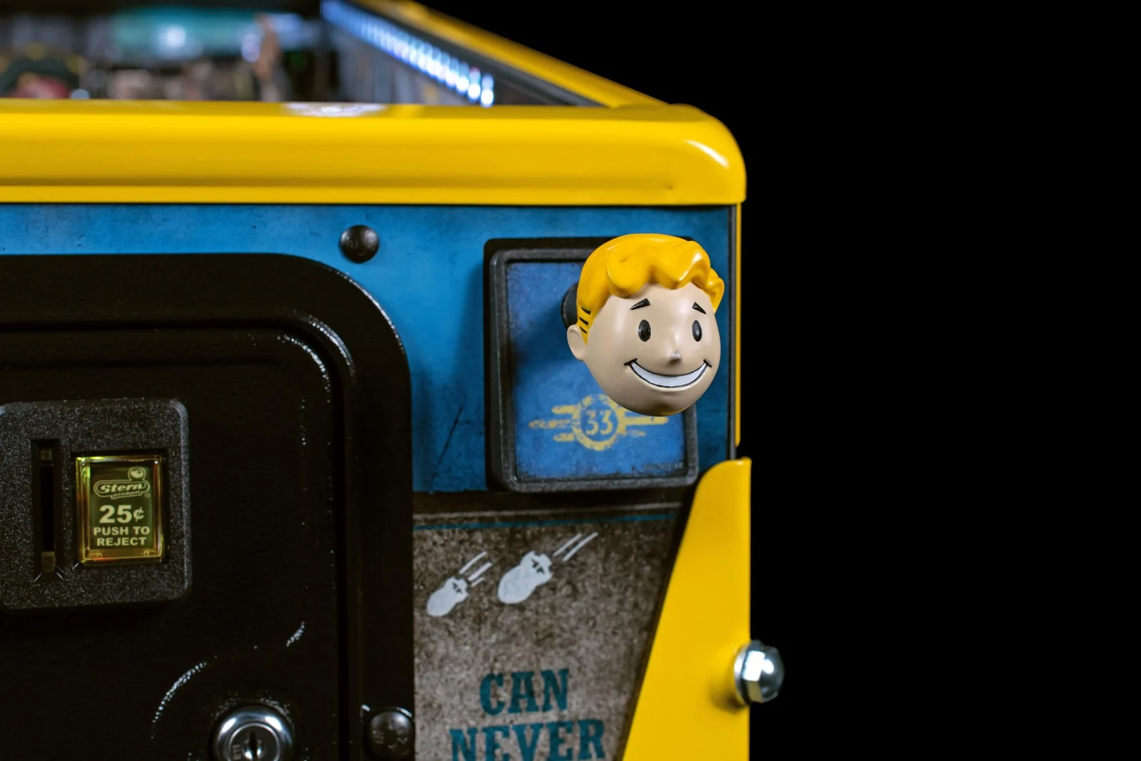 The Vault Boy head shooter knob on the LE, beside the coin door