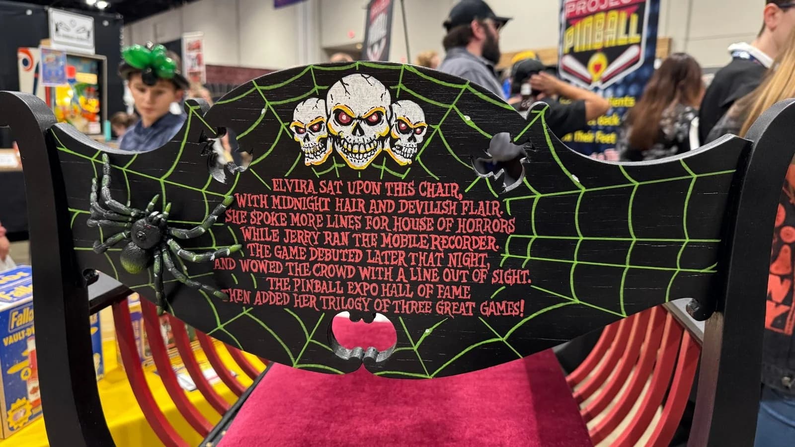 The back of the Elvira chair, with skulls, a spider web and a verse about Elvira