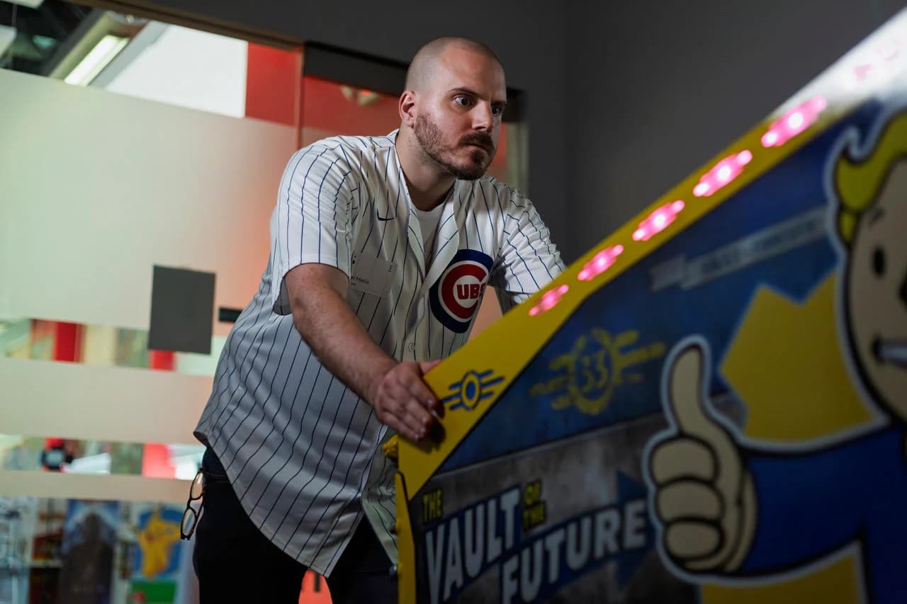 Paul Melio, wide-eyed in a Cubs jersey, at the Fallout Limited Edition with The Vault of the Future side art
