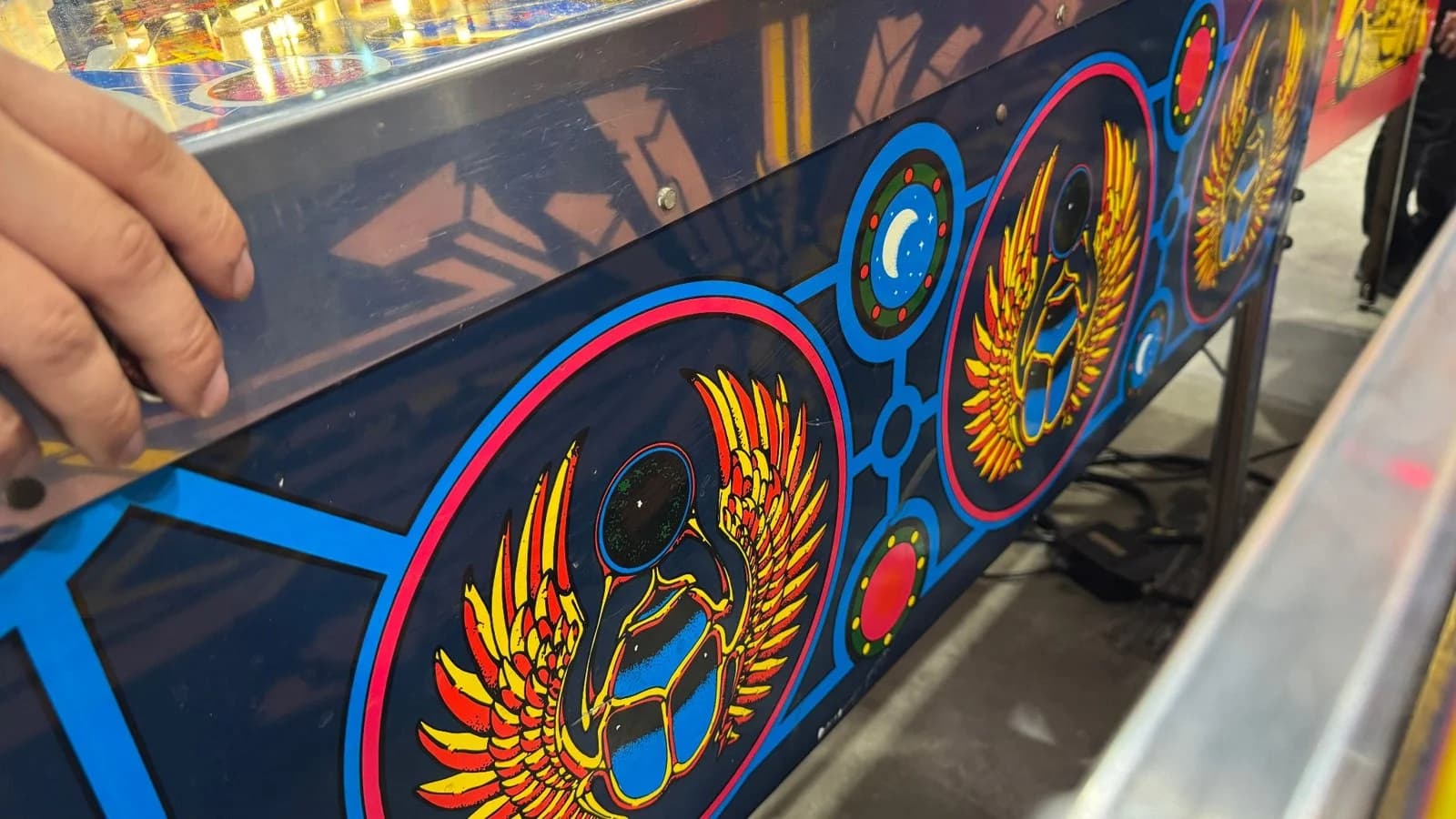 Cabinet art with gold winged scarab designs
