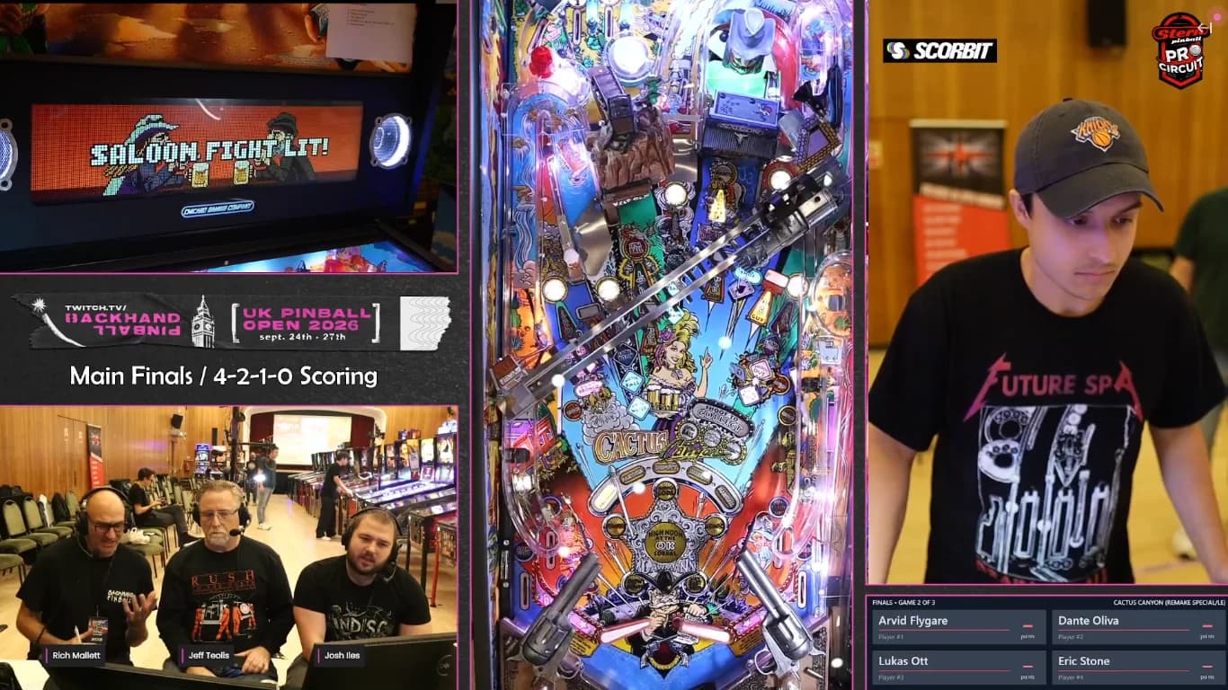 Stream frame of the UK Pinball Open finals showing Dante Oliva at Cactus Canyon Remake, with the playfield and the commentary desk