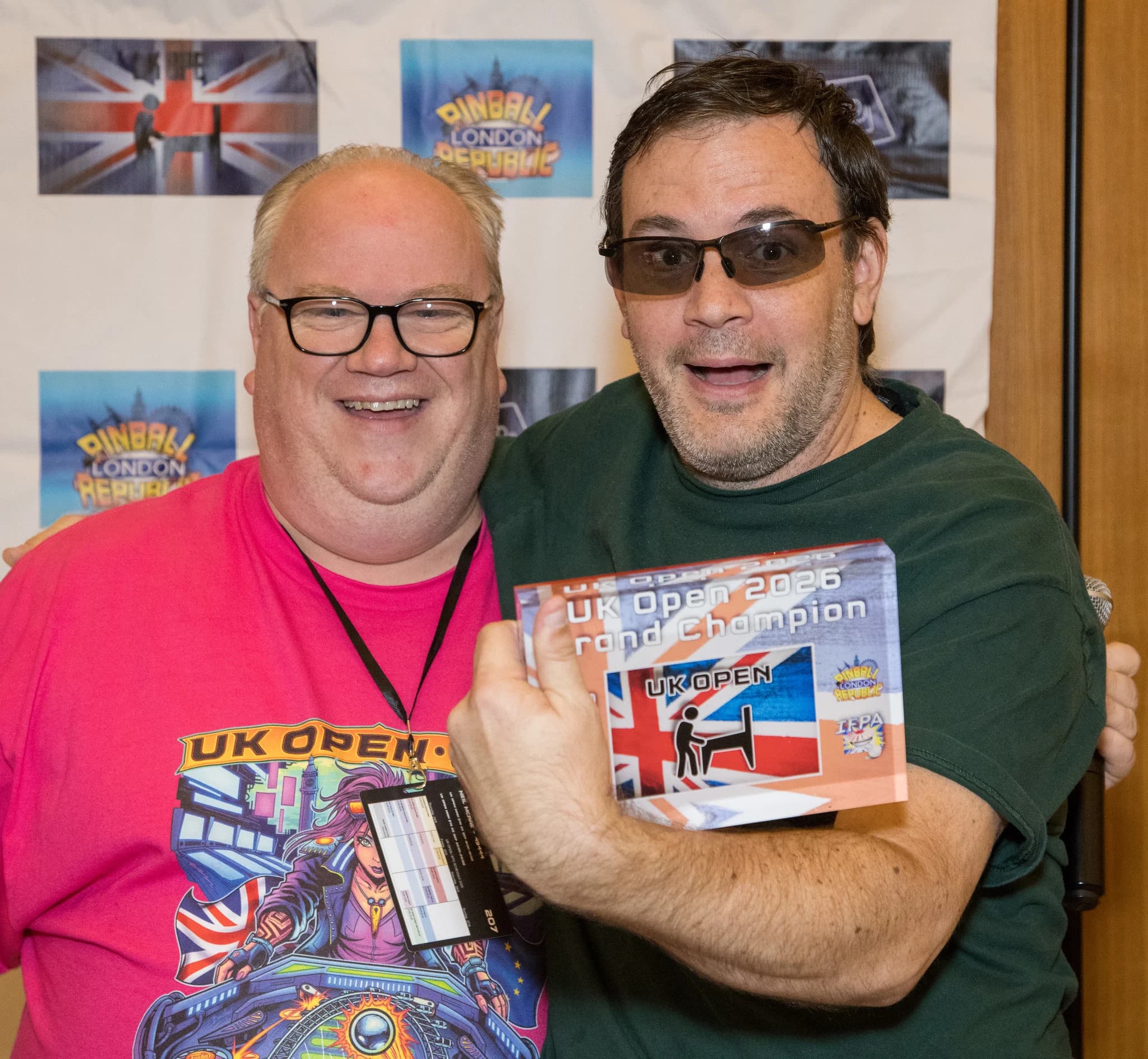 Eric Stone holding his UK Open 2026 Grand Champion award beside a smiling man in a UK Open shirt