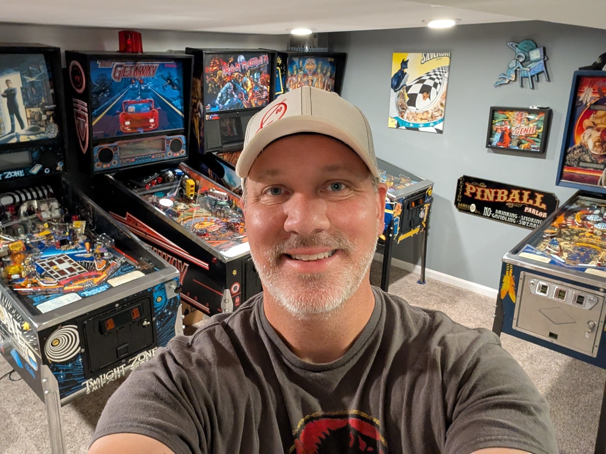 Will Oetting in his gameroom in front of Twilight Zone, The Getaway, and Iron Maiden pinball machines