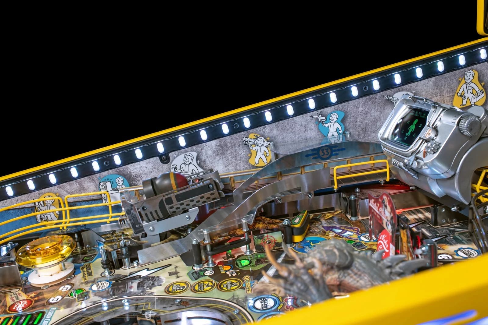 LE cabinet expression lighting along the playfield edge, Vault Boy art on the inside wall