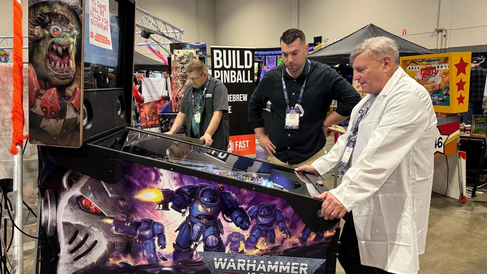 Aaron Small watches as Joe Kaminkow judges his Warhammer 40K homebrew.