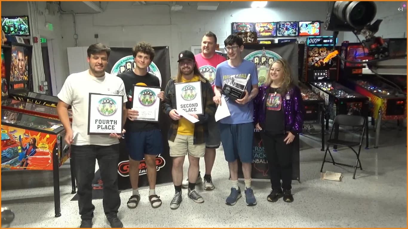 The PAPA 2026 Main A Division top four holding their placement plaques and the championship trophy at The Pinball Capital