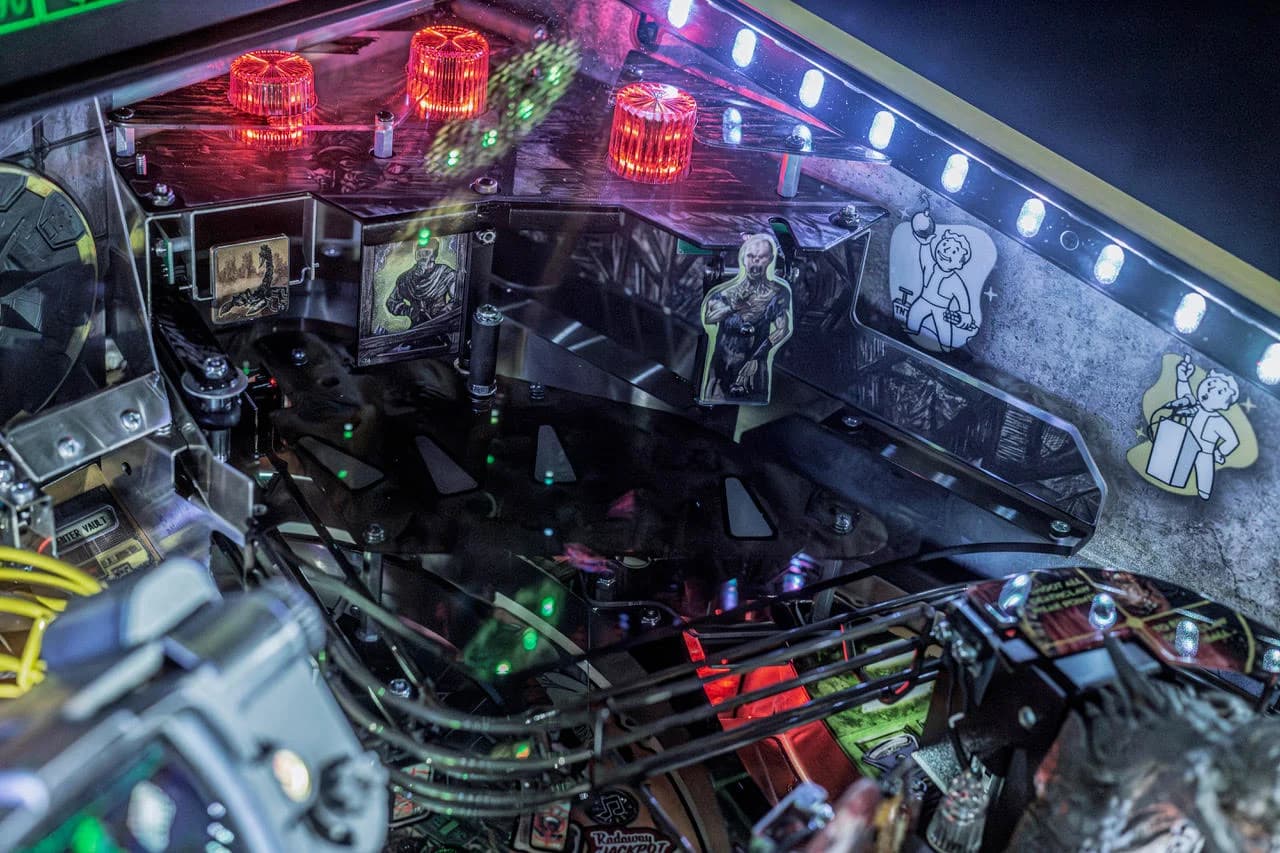 The upper playfield target gallery on the Premium and Limited Edition: Radscorpion, Ghoul and Vault Boy targets under red lights