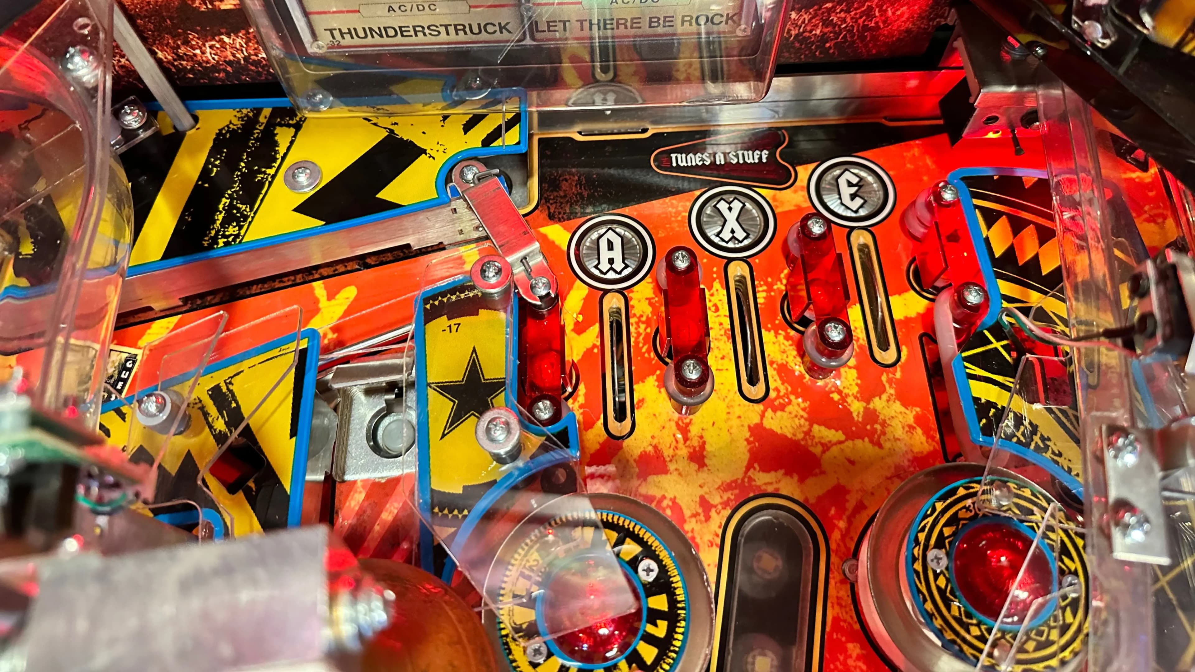 Colorful AC/DC pinball machine with red, yellow, and blue design elements