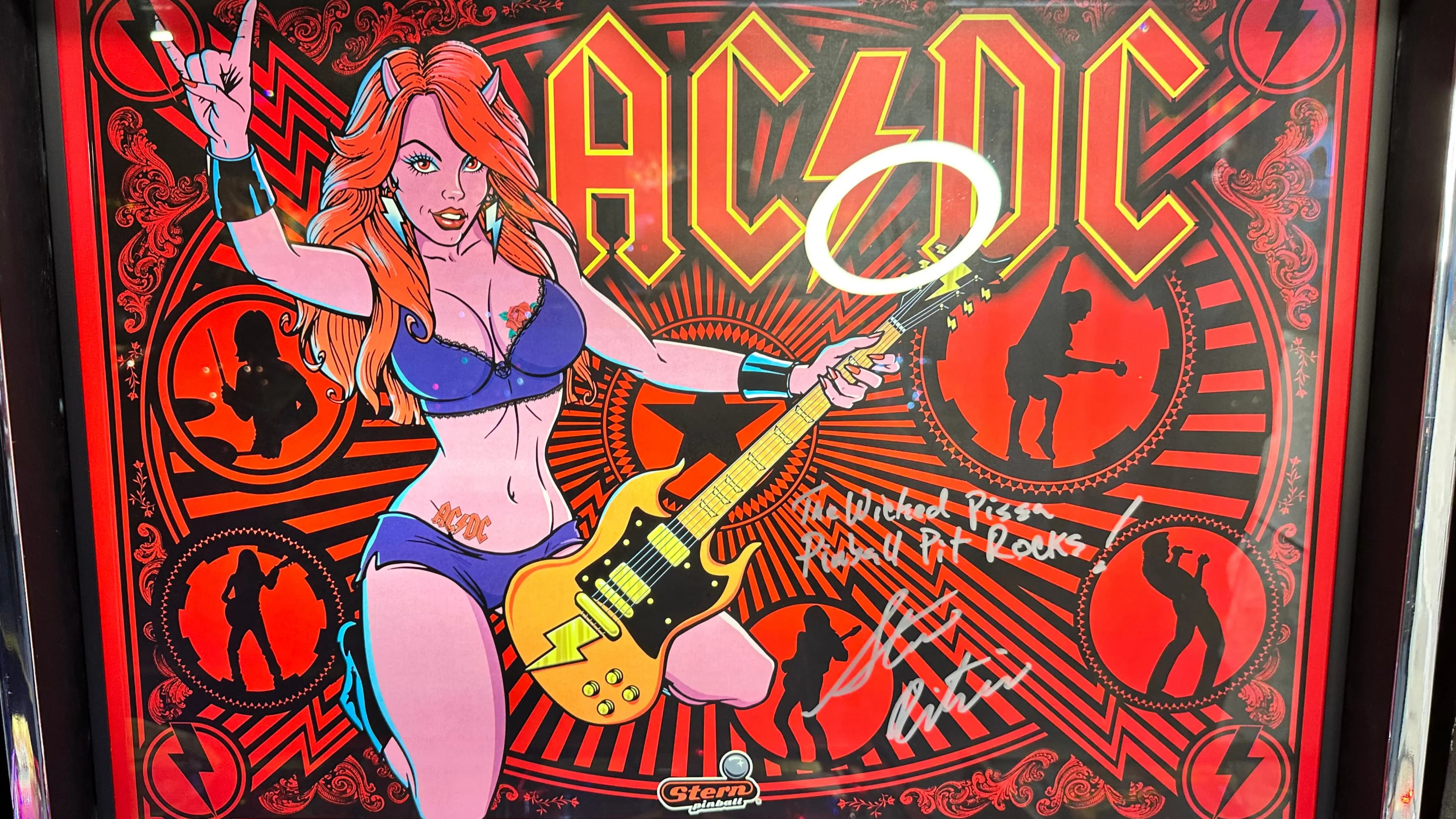 AC/DC pinball art with rock-themed woman and electric guitar