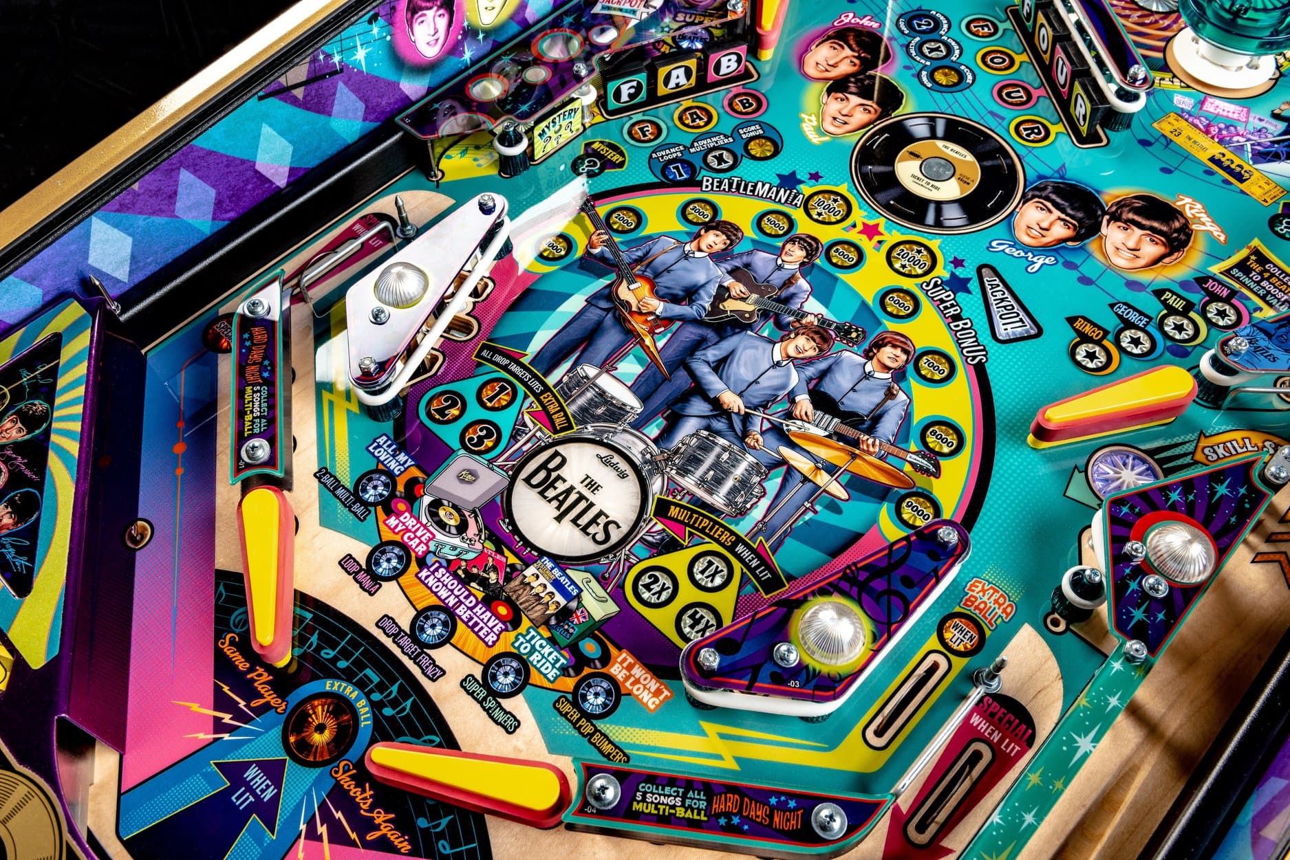 Colorful Beatles-themed pinball machine with band members and music icons