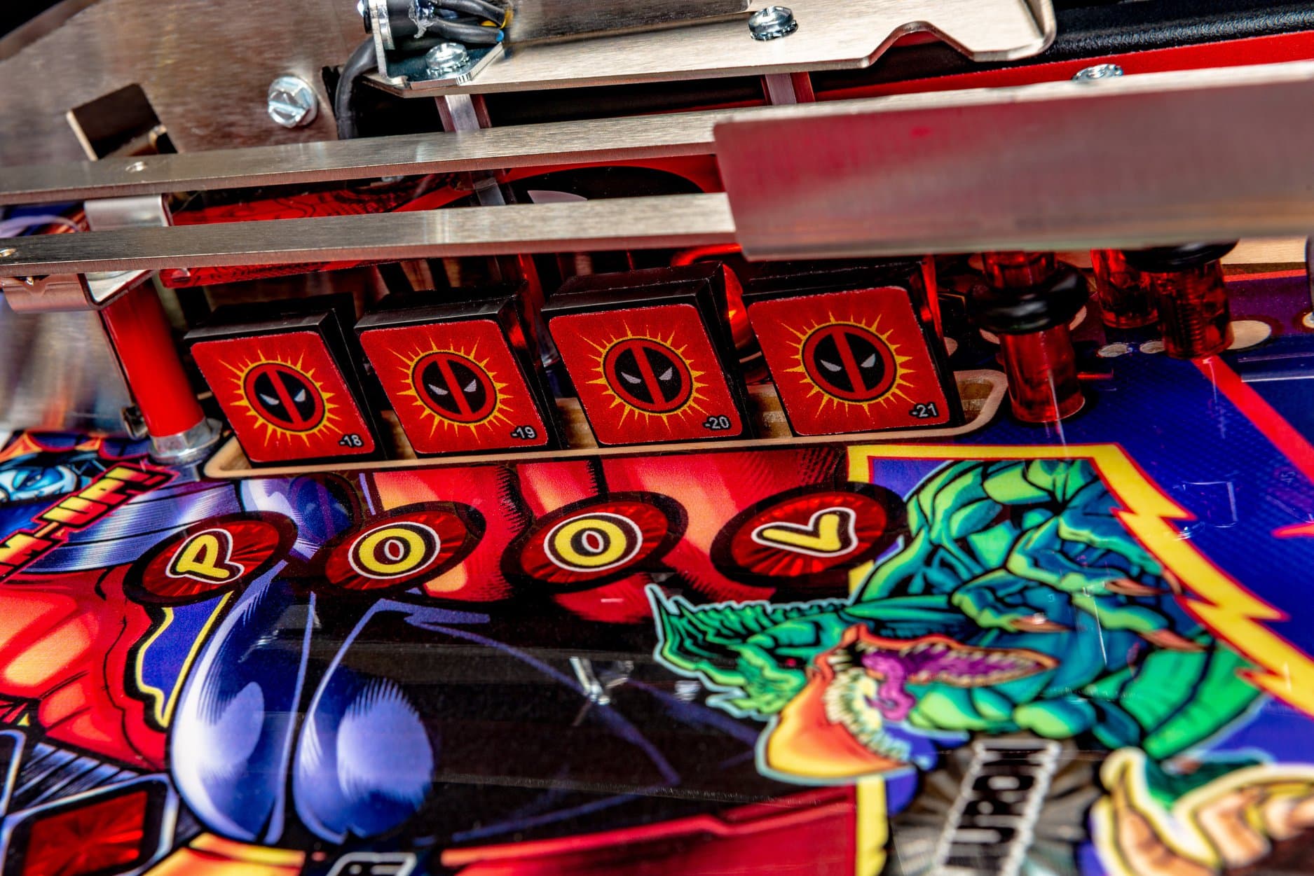 Deadpool-themed pinball machine with colorful playfield and numbered targets
