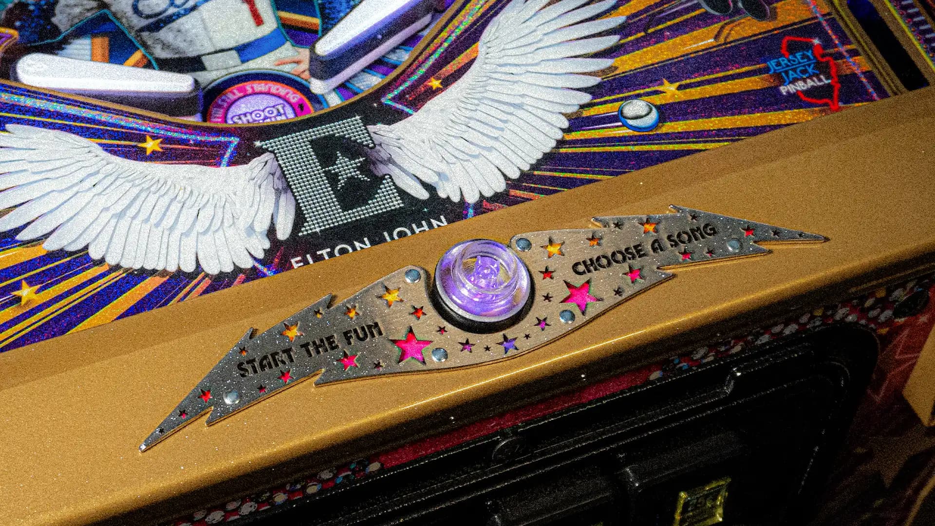 Elton John pinball machine with winged design and colorful star decorations