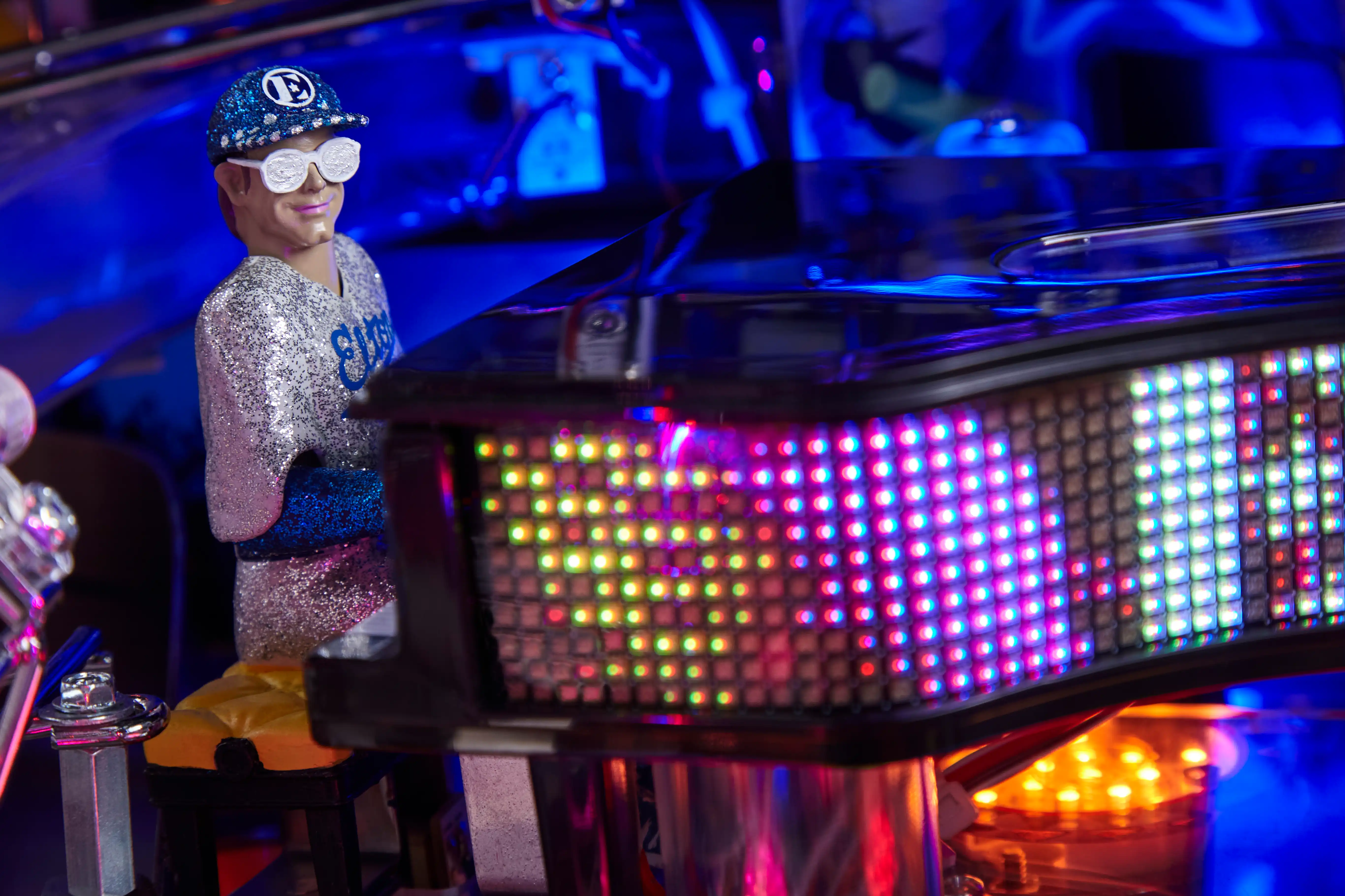 Glittery figurine near colorful LED display with blue lighting