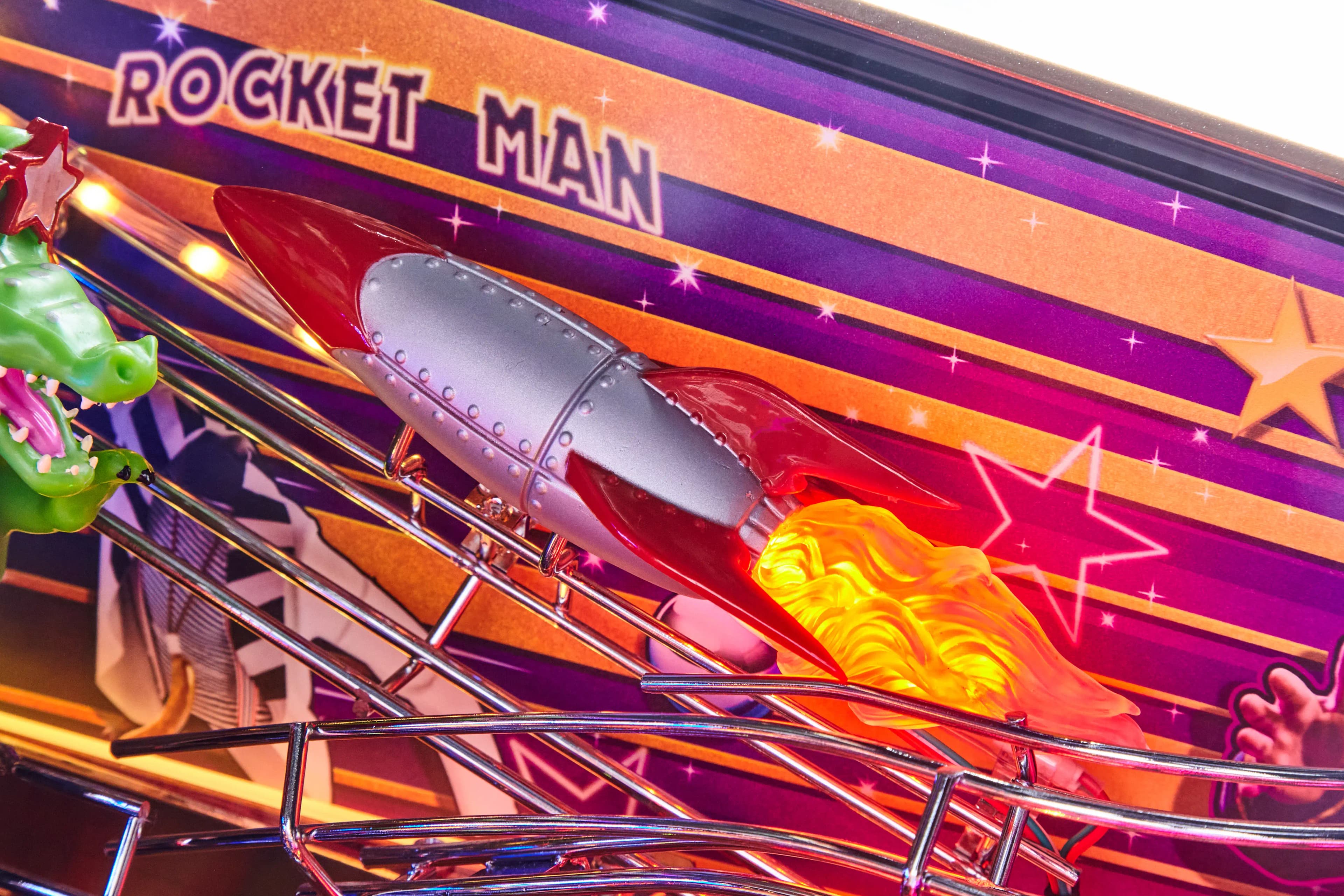 Rocket Man pinball machine with silver rocket, flames, and colorful stars