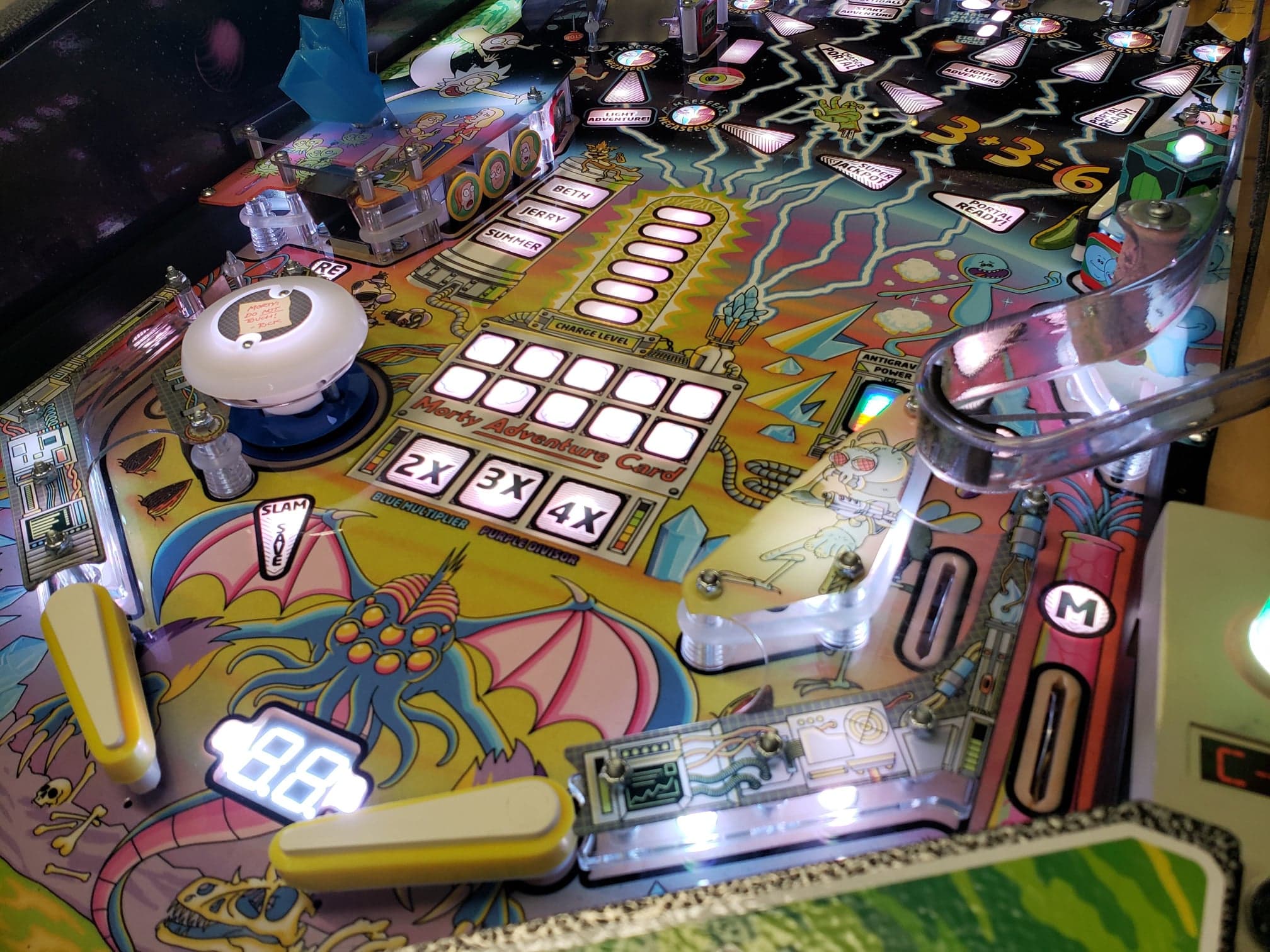 Colorful pinball machine with fantastical monster and electronic game board