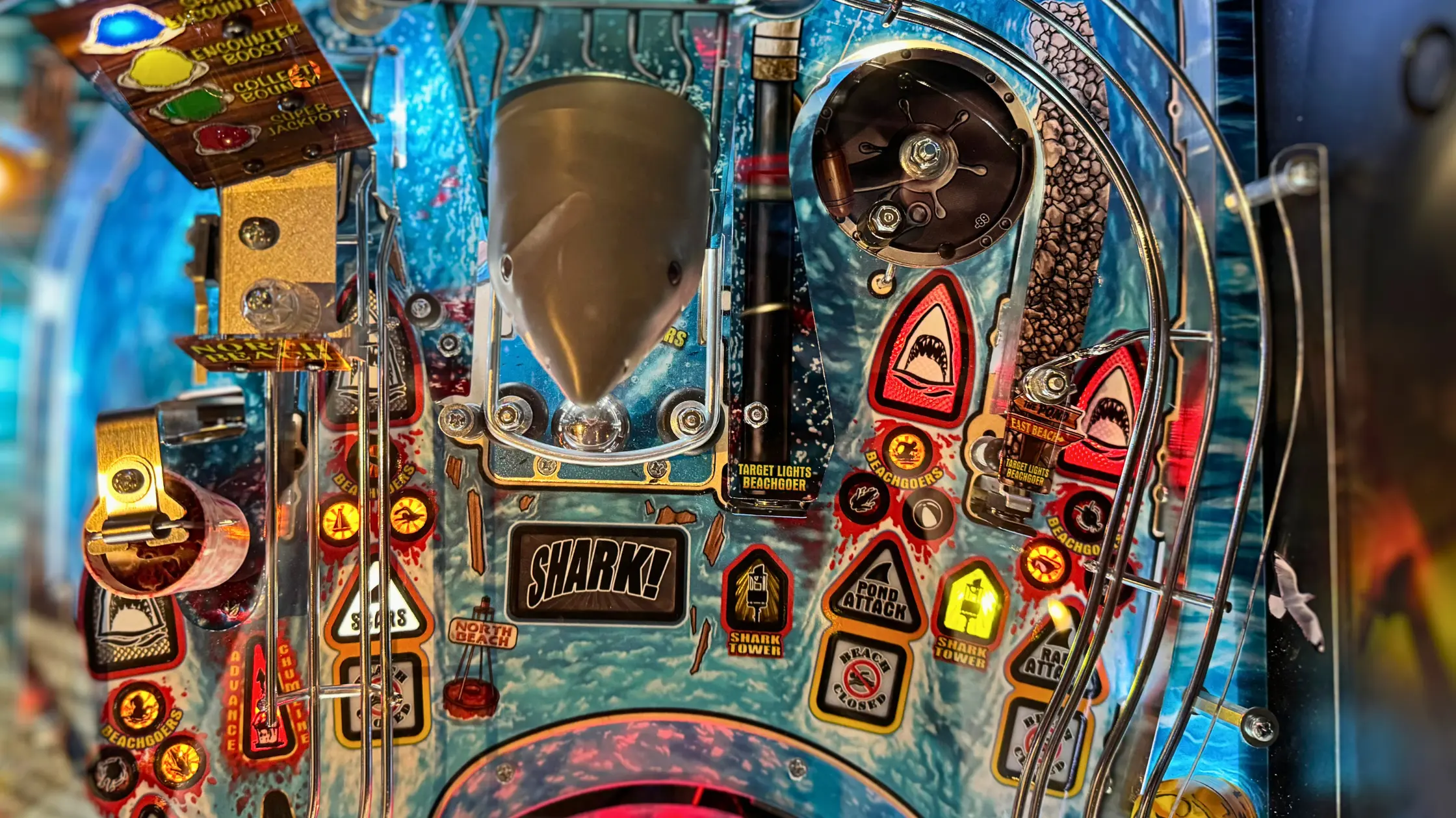 Detailed shark-themed pinball machine with colorful lights and intricate design
