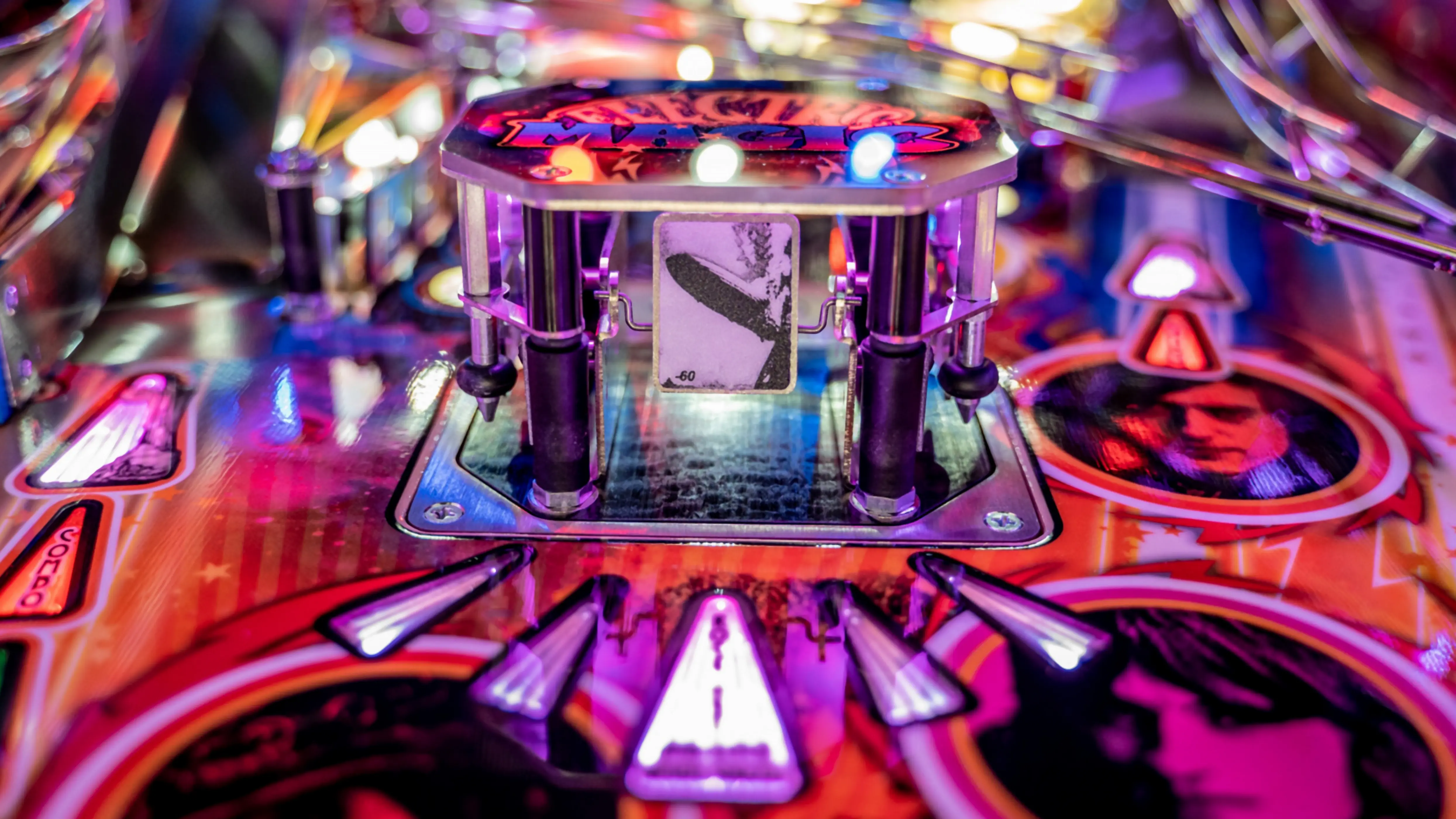Colorful pinball machine with vibrant lights and detailed playfield design