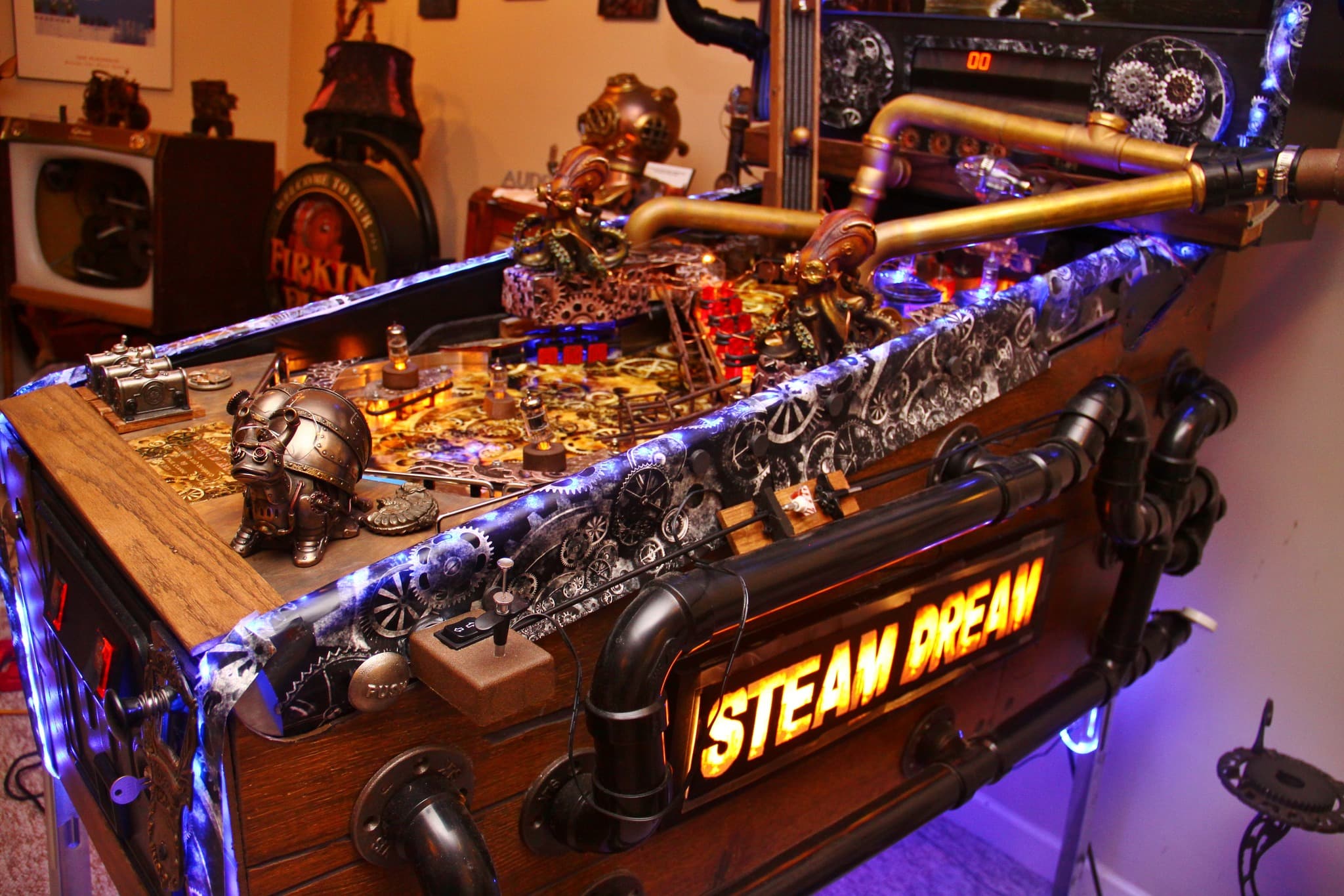 Steampunk-themed custom gaming device with gears, pipes, and blue lighting