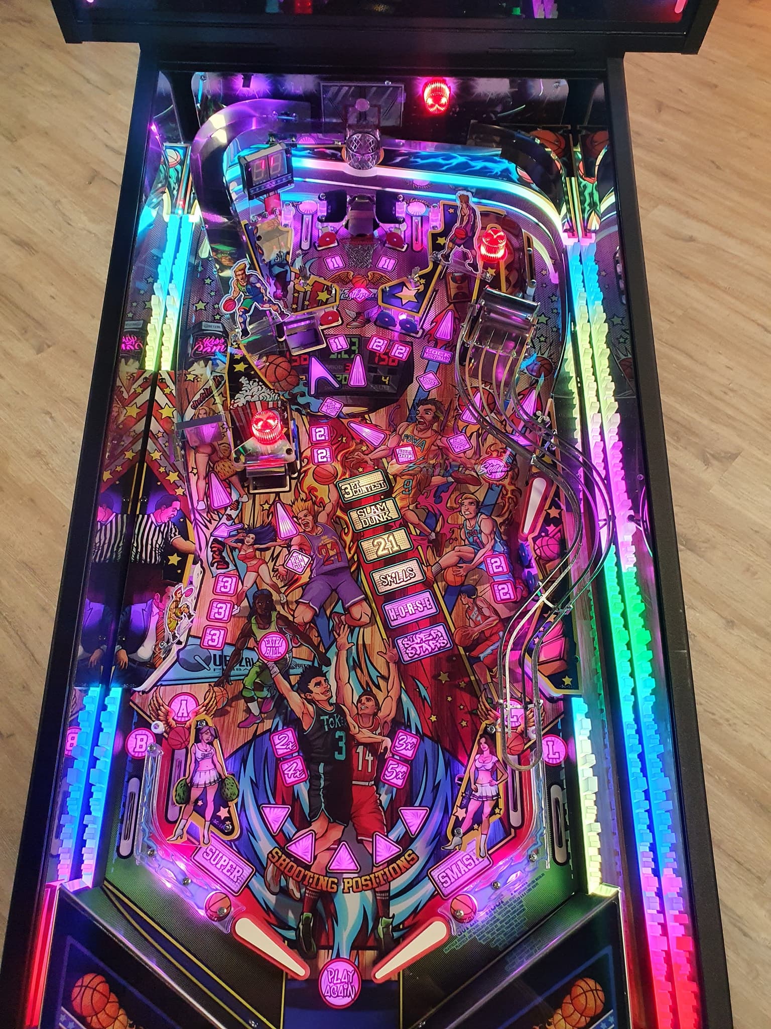 Colorful basketball-themed pinball machine with vibrant neon lights and characters