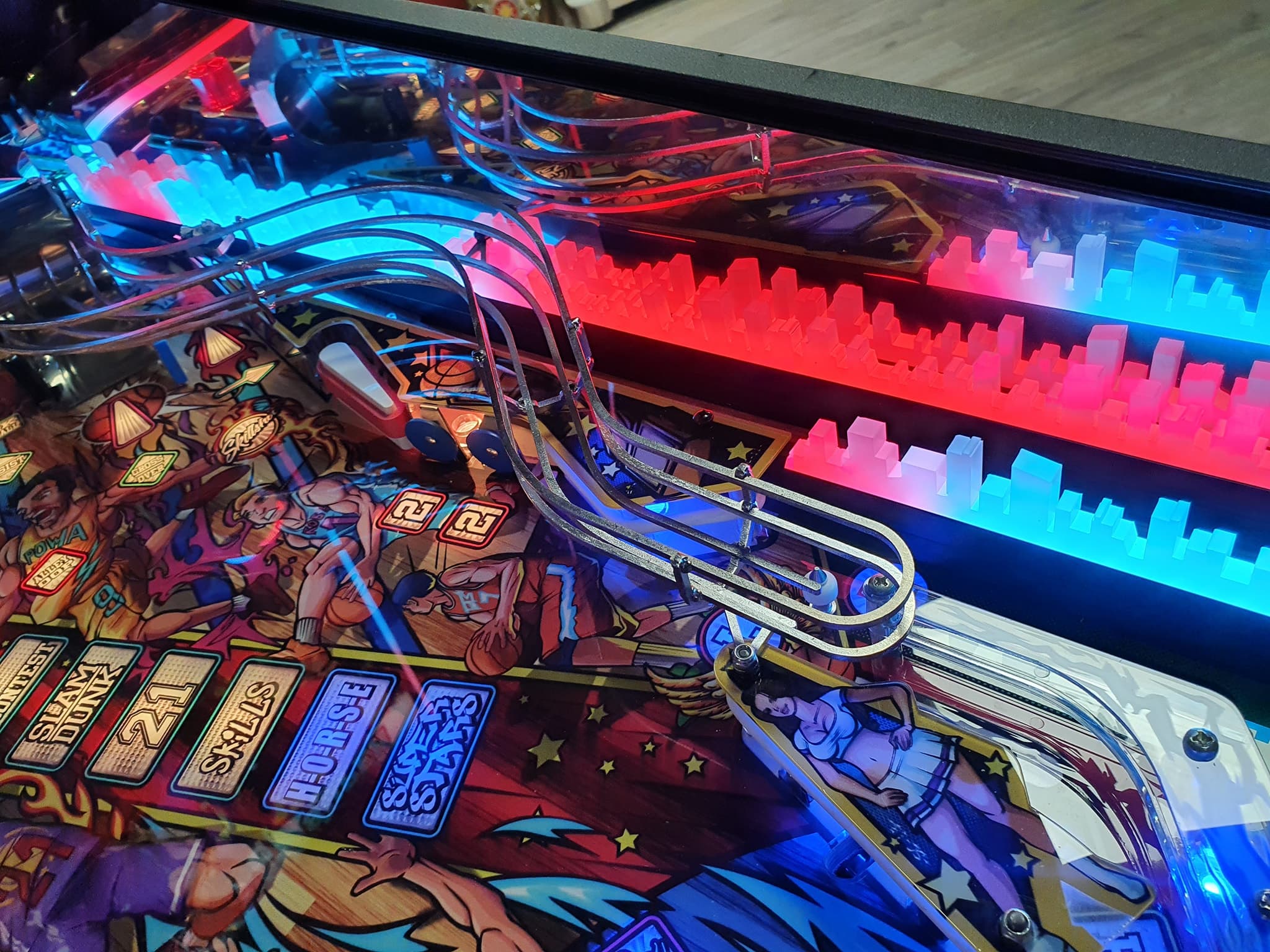 Colorful pinball machine with vibrant artwork and metallic ball track