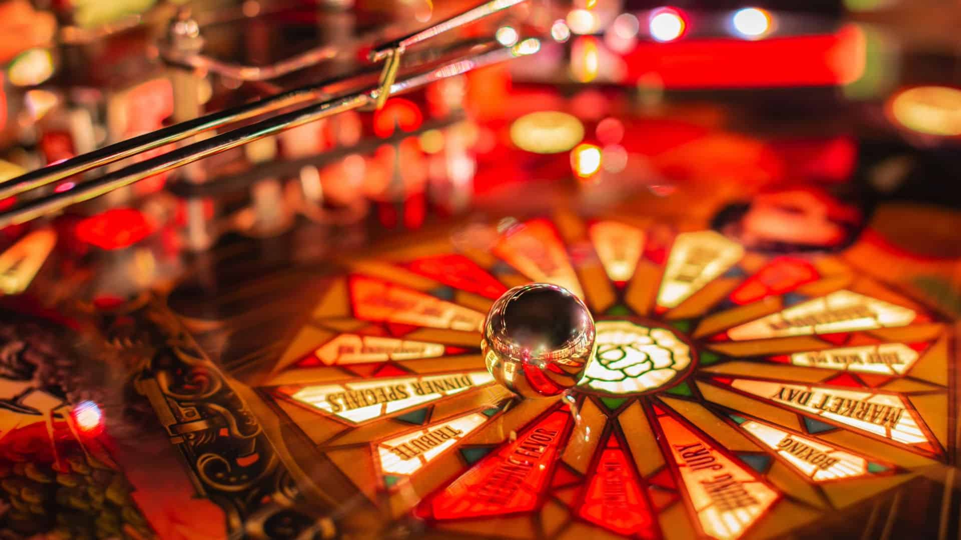 Shiny pinball with colorful game board, lights, and metallic elements