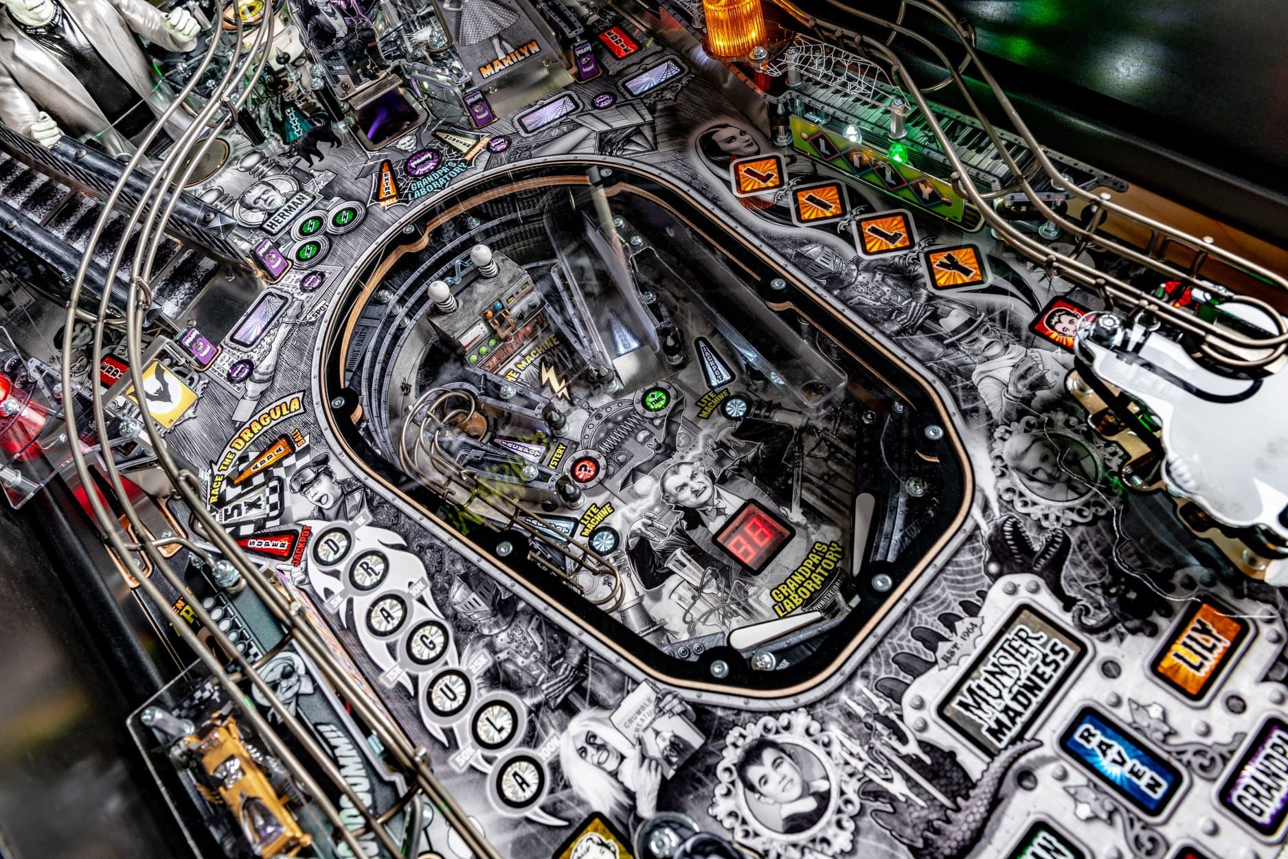 Intricate pinball machine with complex design, buttons, and graphic details