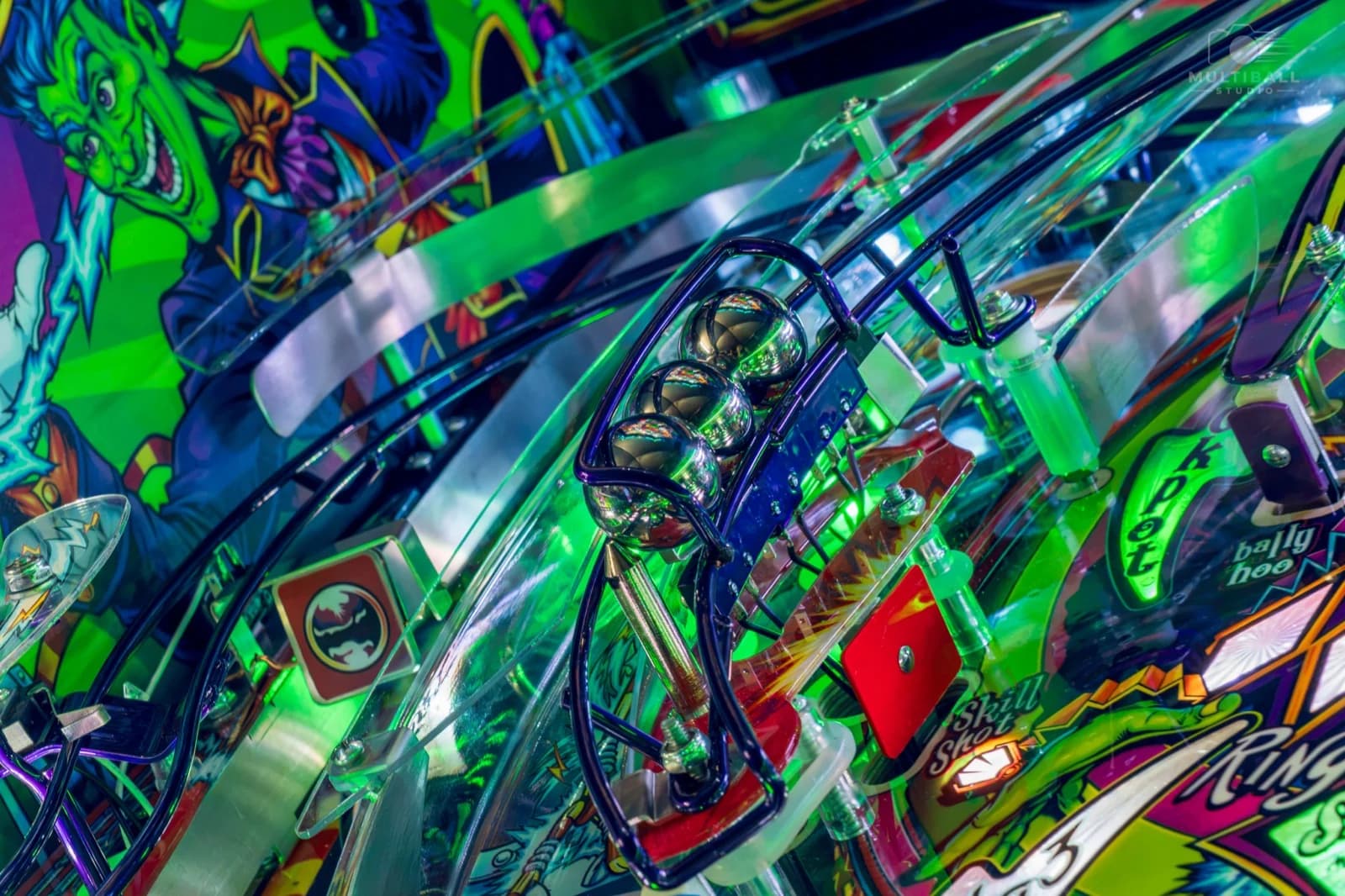 Three pinballs held in a wire-ramp lock on the Cirqus Voltaire playfield
