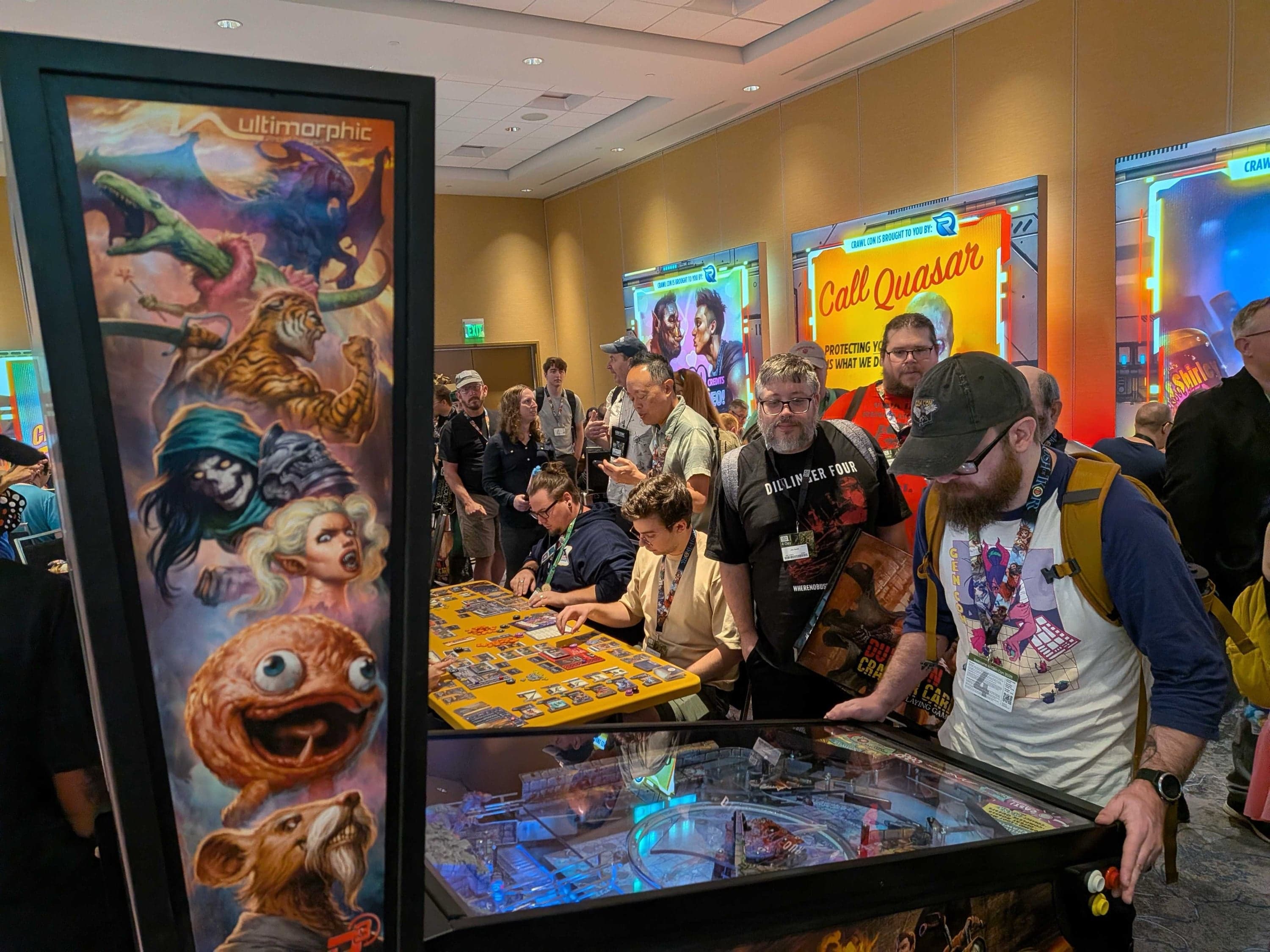 Convention attendees playing Dungeon Crawler Carl pinball, with Crawl Con banners lit behind them