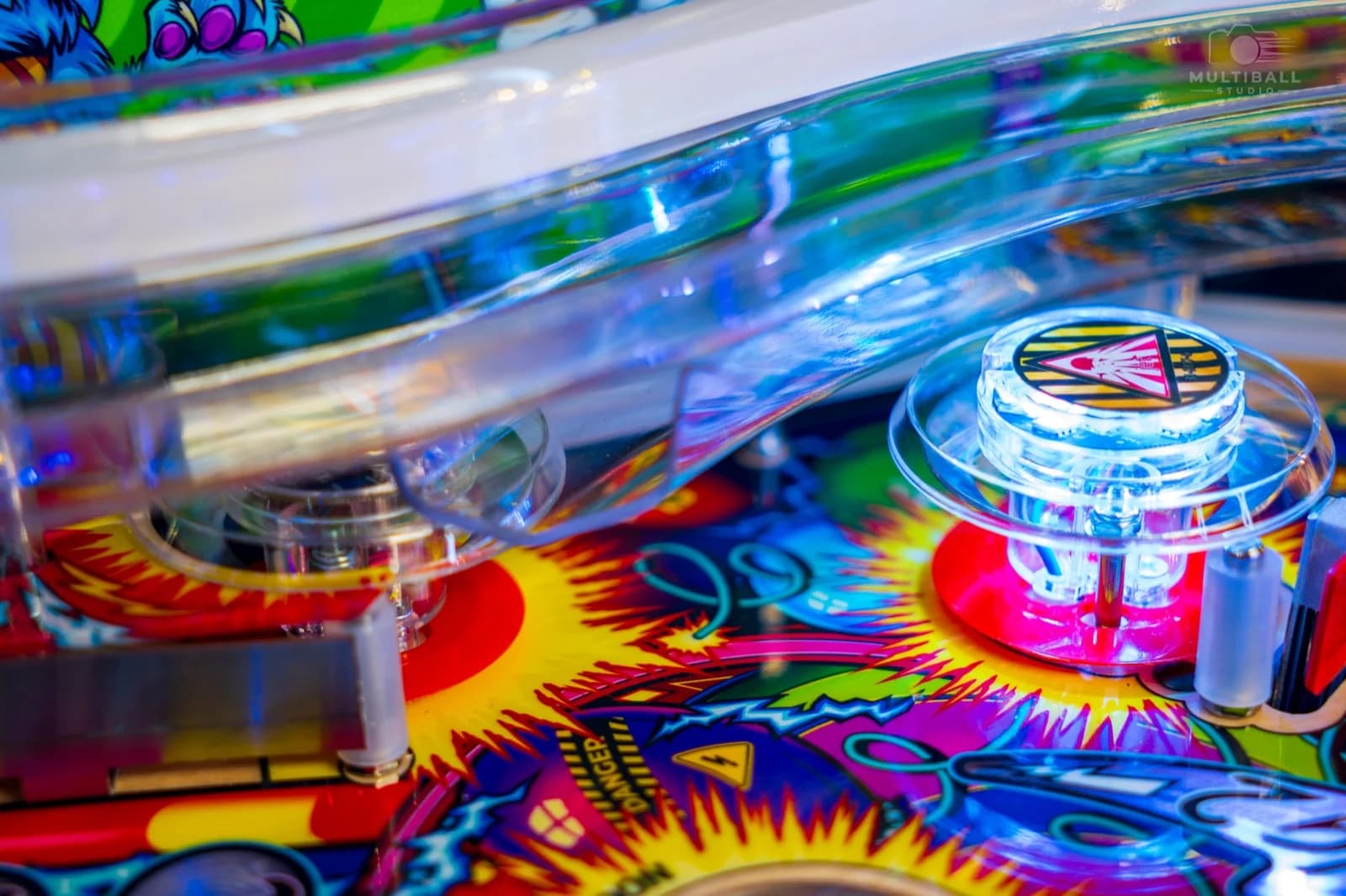 Clear plastic ramps above a lit pop bumper on the Cirqus Voltaire playfield