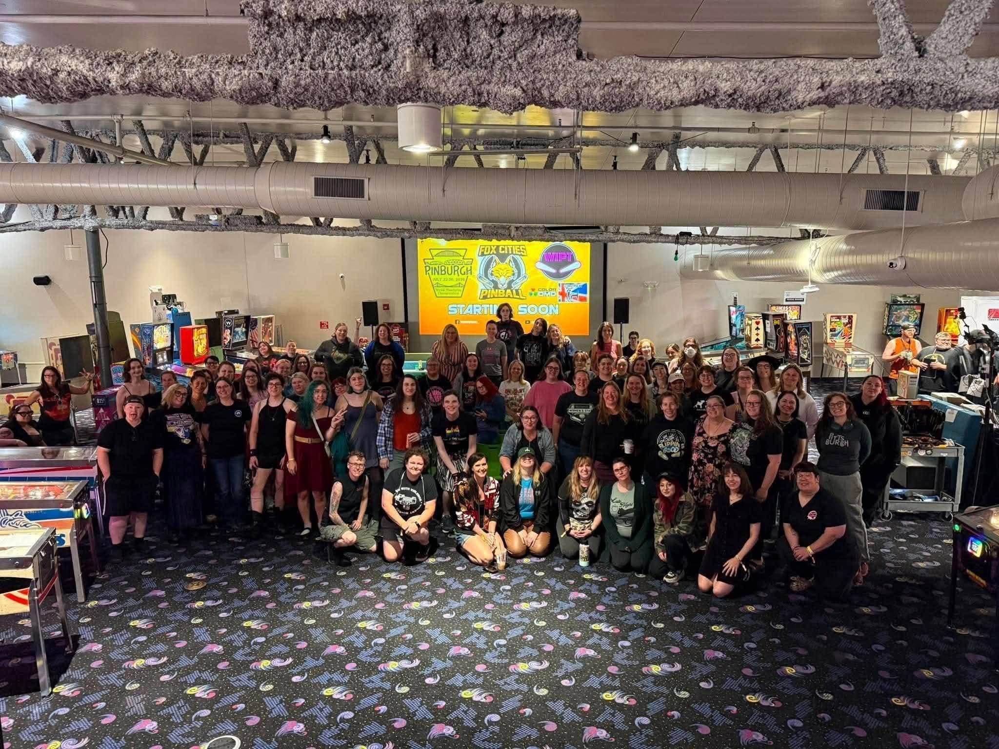 The field of players at the 2026 Women's International Pinball Tournament gathered for a group photo