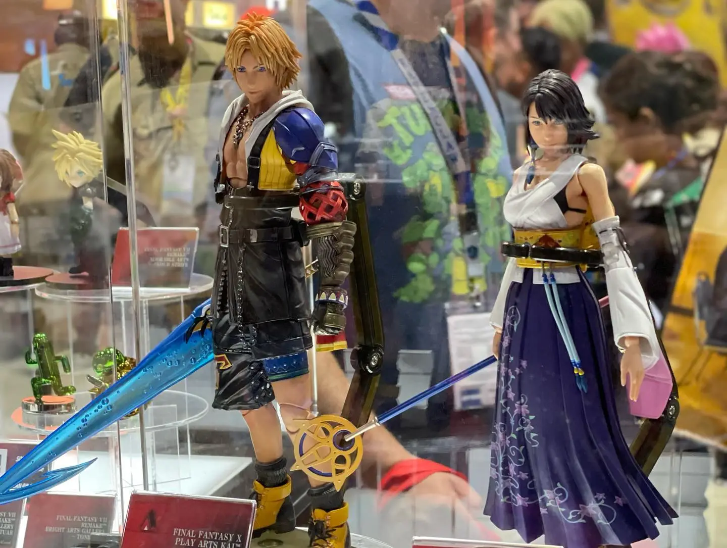 Final Fantasy X action figures of Tidus and Yuna behind glass display
