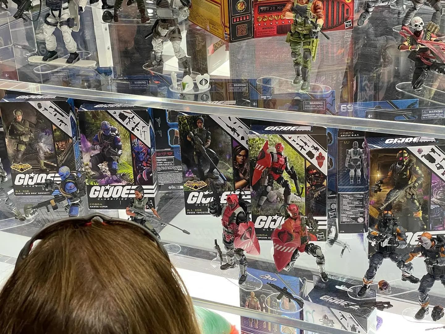 G.I. Joe action figures displayed in glass cases with various characters