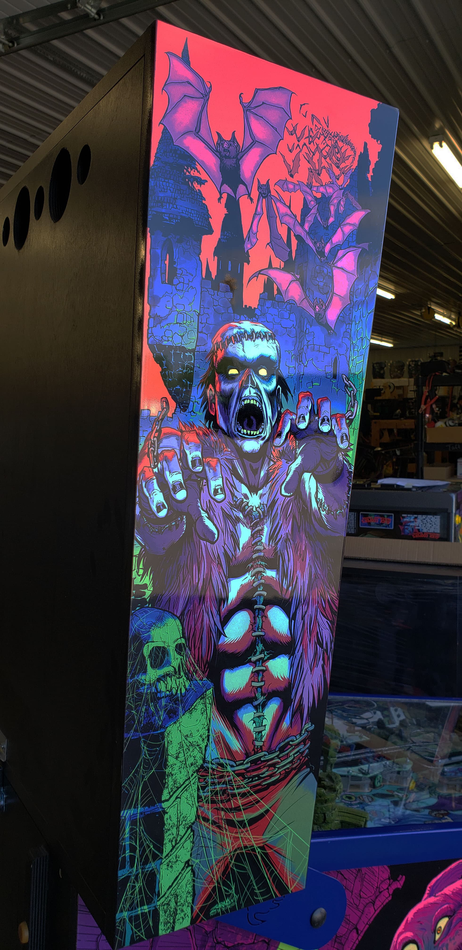 Supernatural horror artwork with screaming zombie, bats, and glowing colors