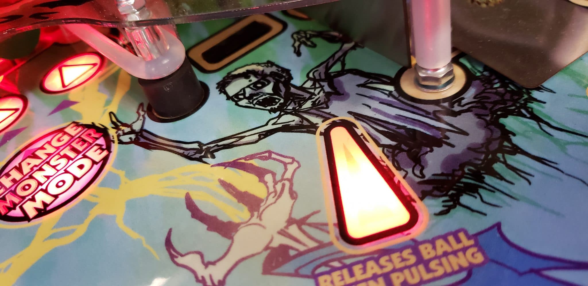 Pinball machine playfield with colorful graphic of stylized character