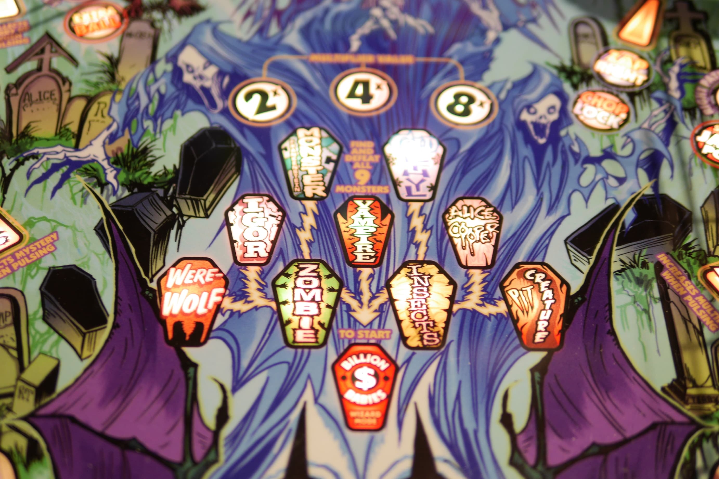 Spooky pinball machine with monster-themed coffin-shaped targets