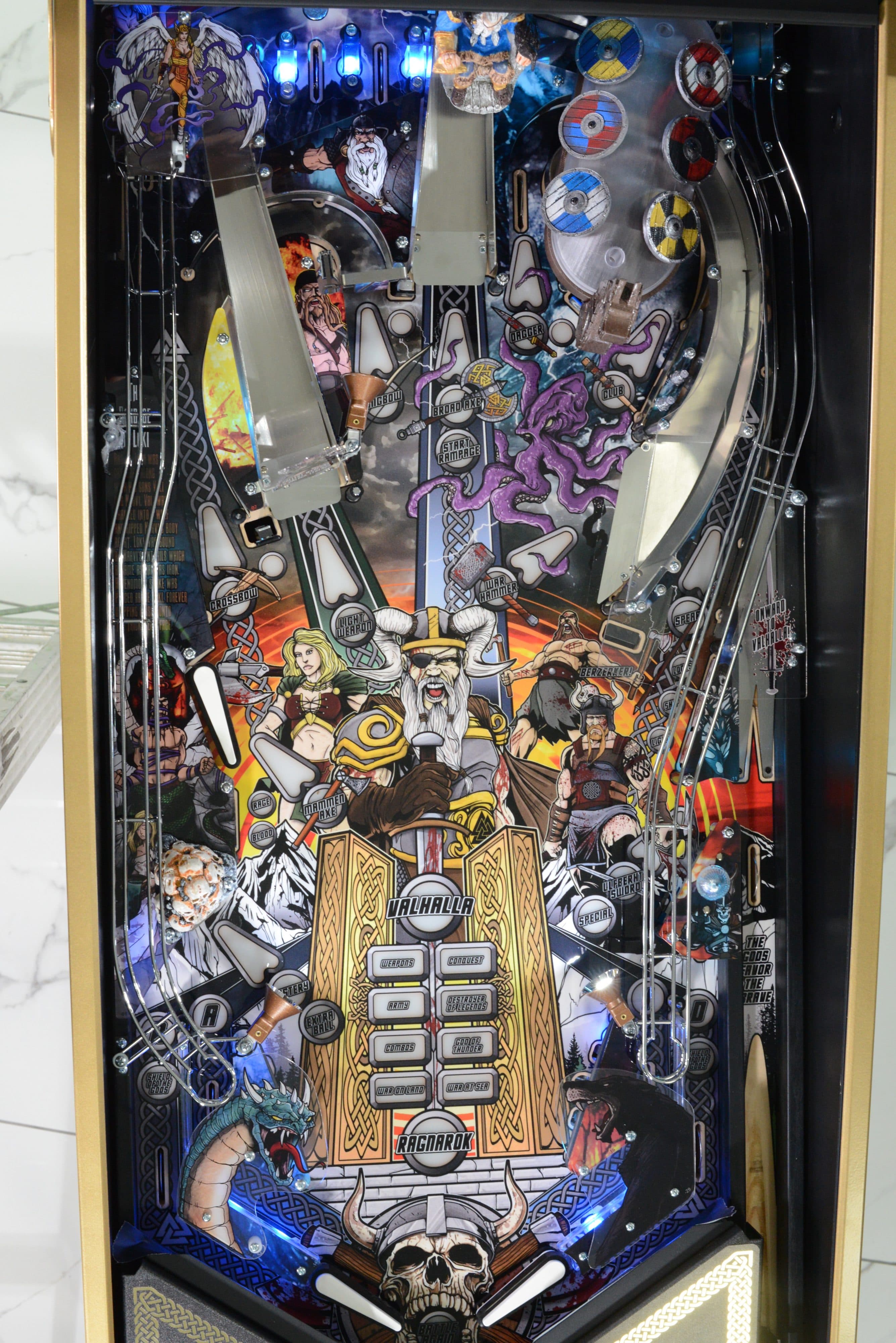 Norse mythology-themed pinball machine with warriors, gods, and mythical creatures
