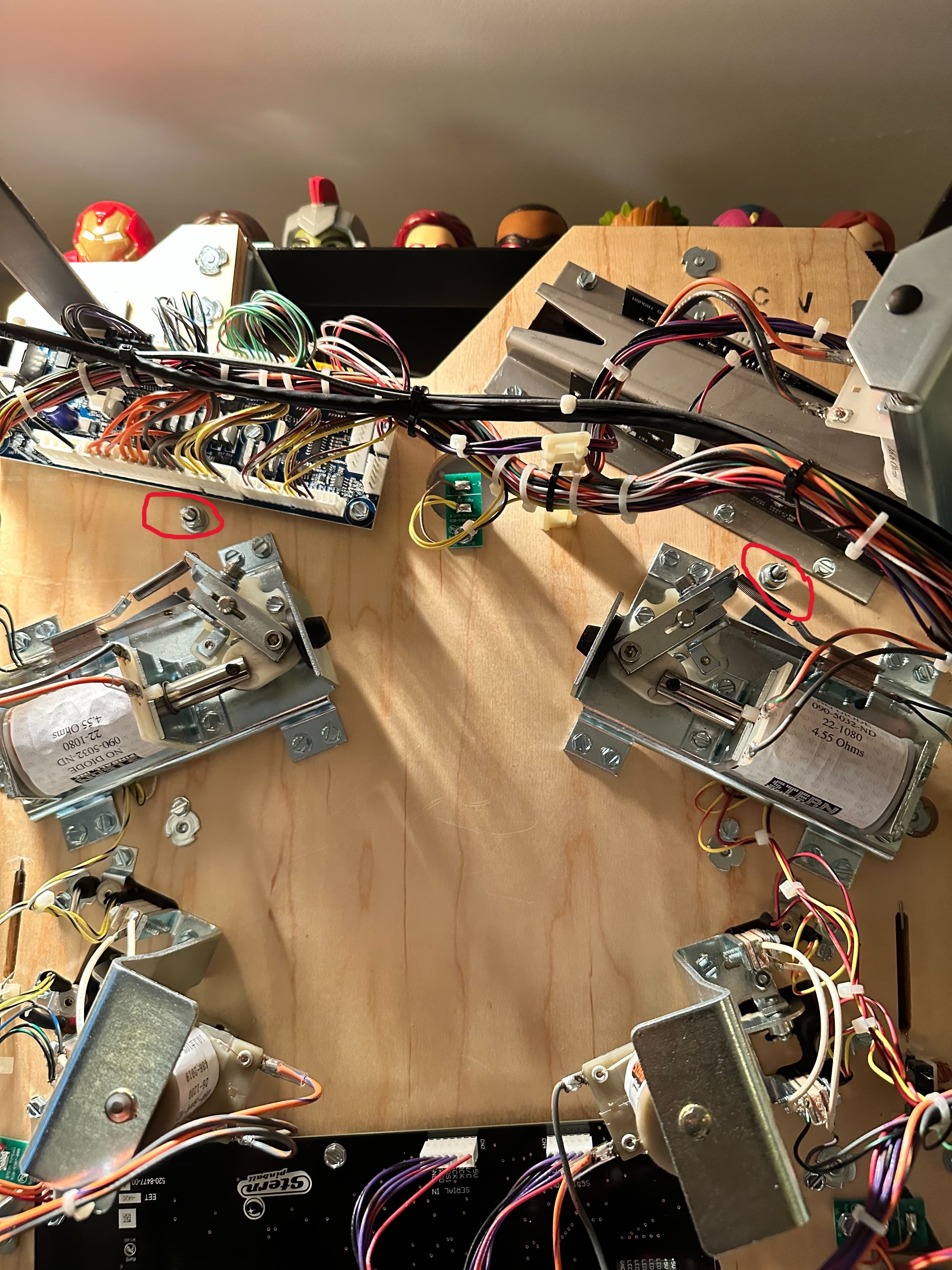 Complex wiring and electrical components on a wooden board with toys