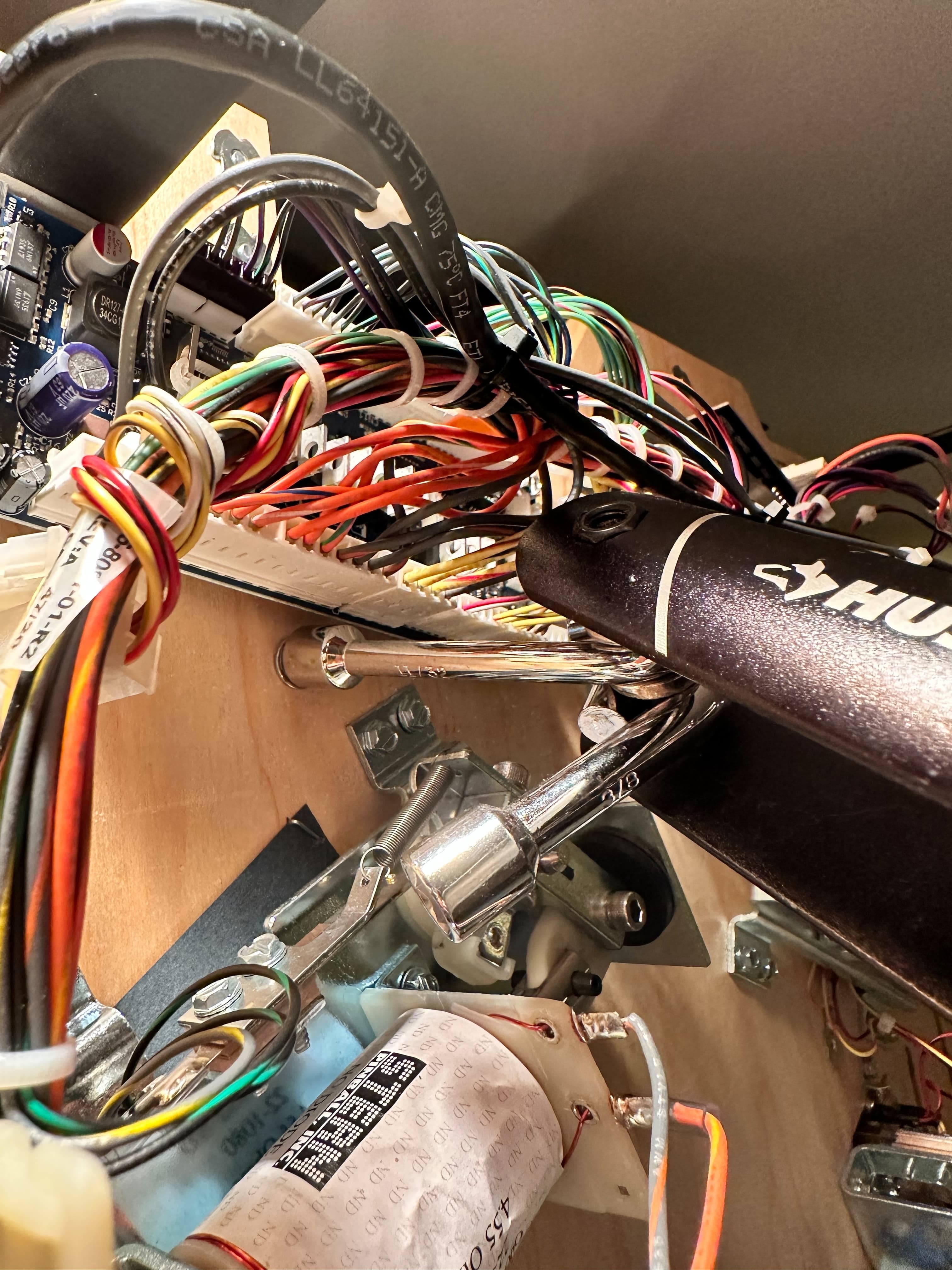 Tangled colorful electrical wires and components in a complex electronic setup