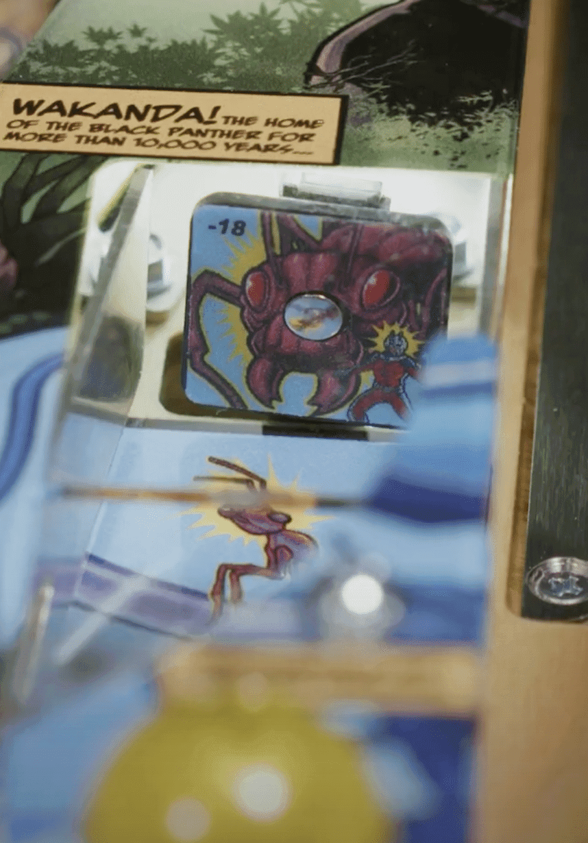 Wakanda comic card with red creature and small figure