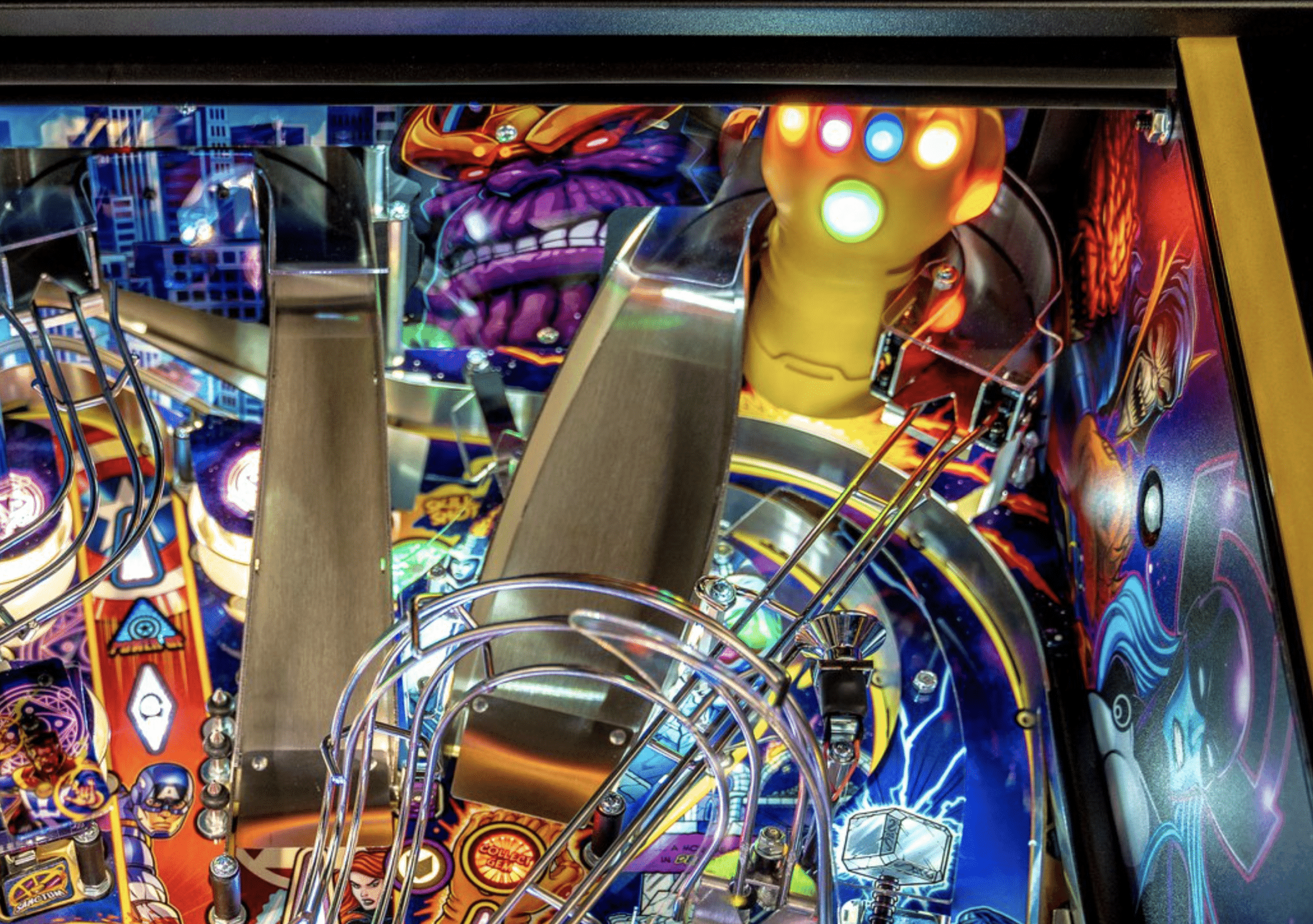 Colorful superhero-themed pinball machine with intricate mechanical details