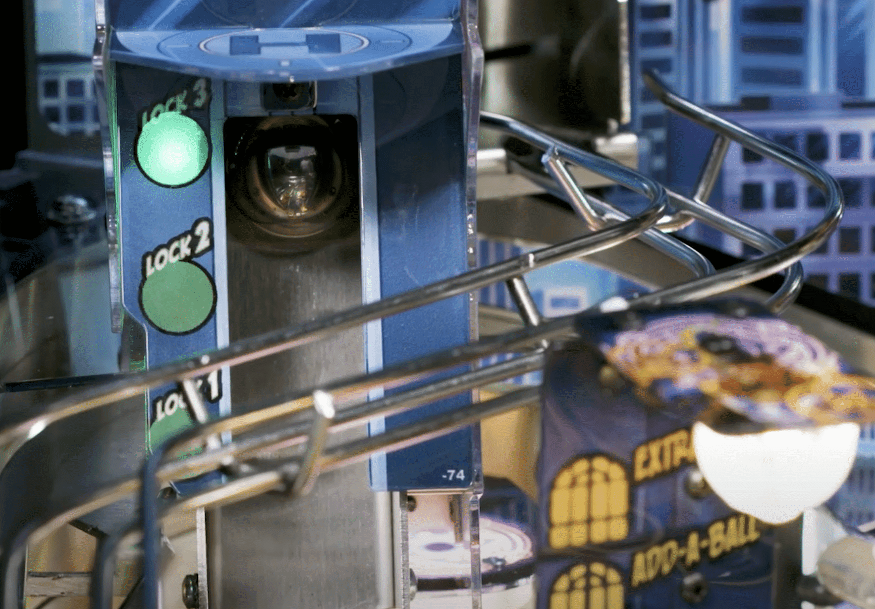 Pinball machine with green lit locks and silver mechanical components