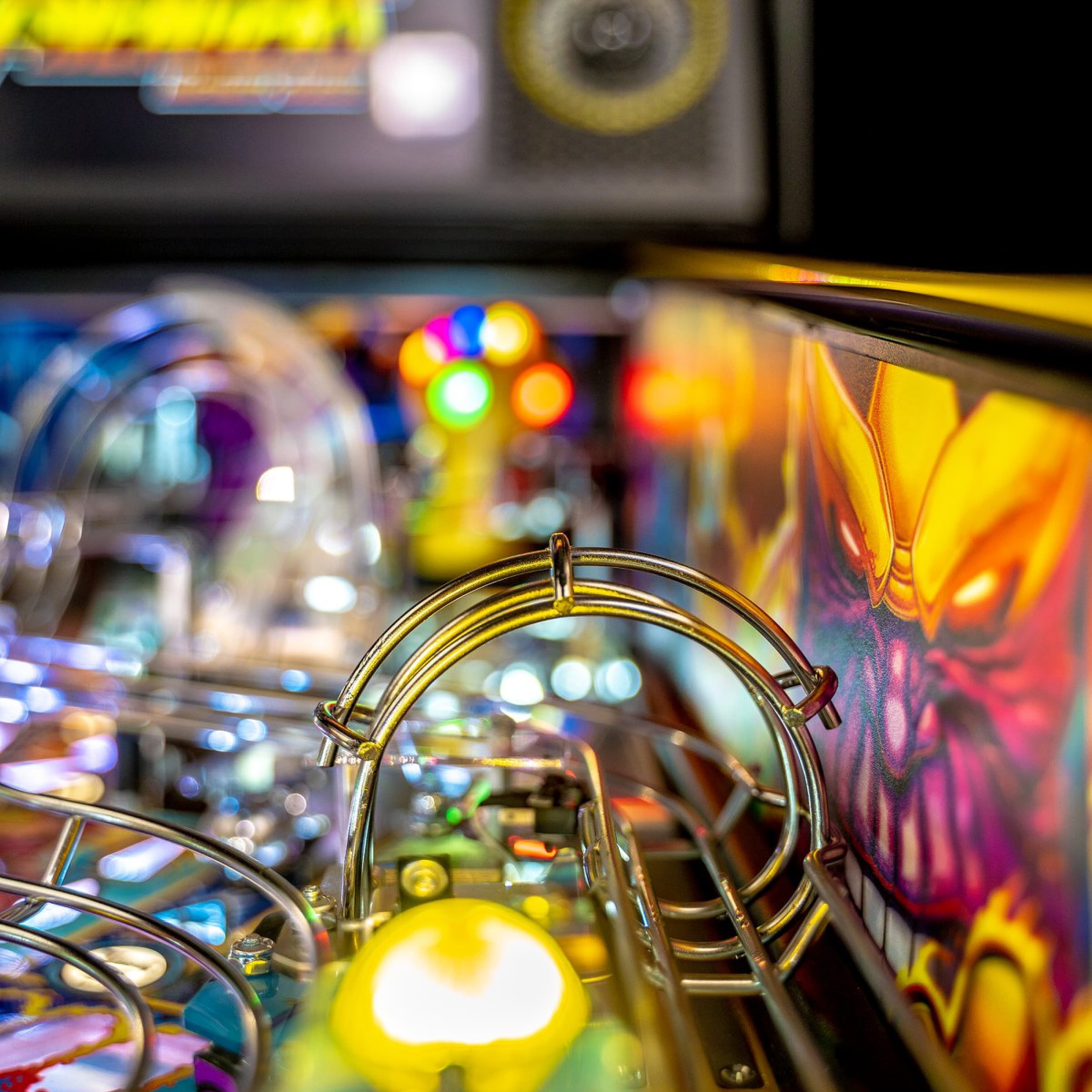 Colorful pinball machine with bright lights and metallic elements