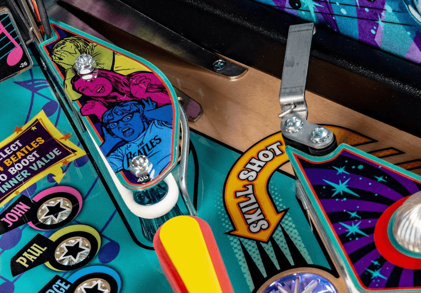 The Beatles pinball machine with colorful artwork and flippers
