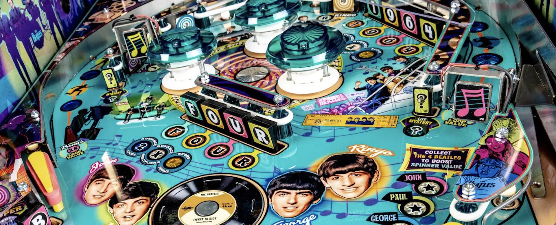 Colorful Beatles-themed pinball machine with band members and musical symbols