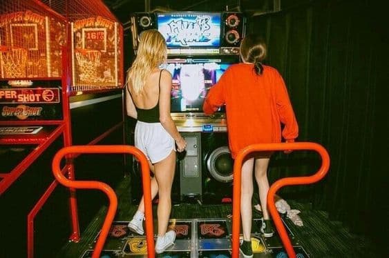 playing dance dance revolution ddr arcade machine