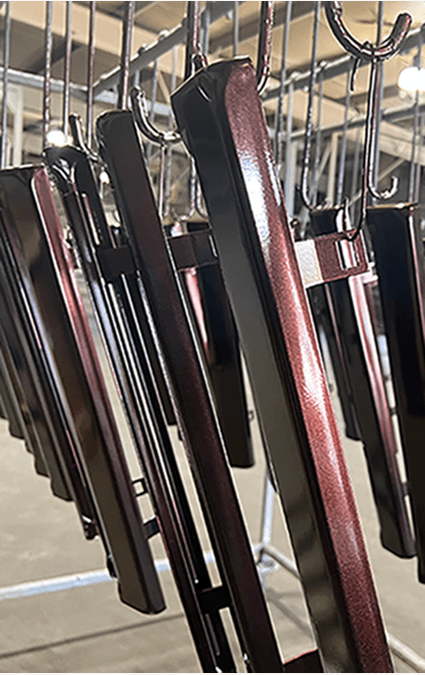 Multiple belts hanging on hooks in rows at a store or display