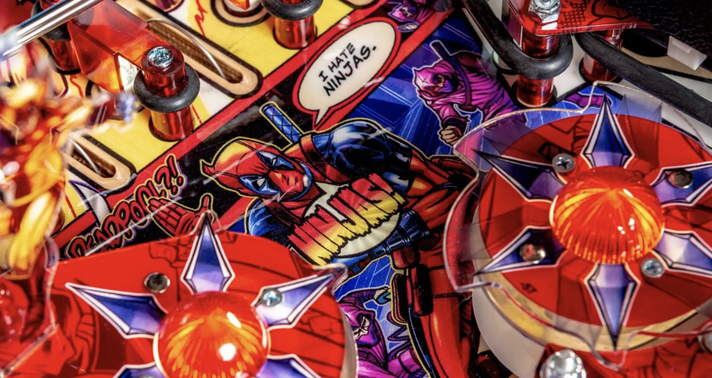 Colorful comic book pinball machine with superhero characters and action